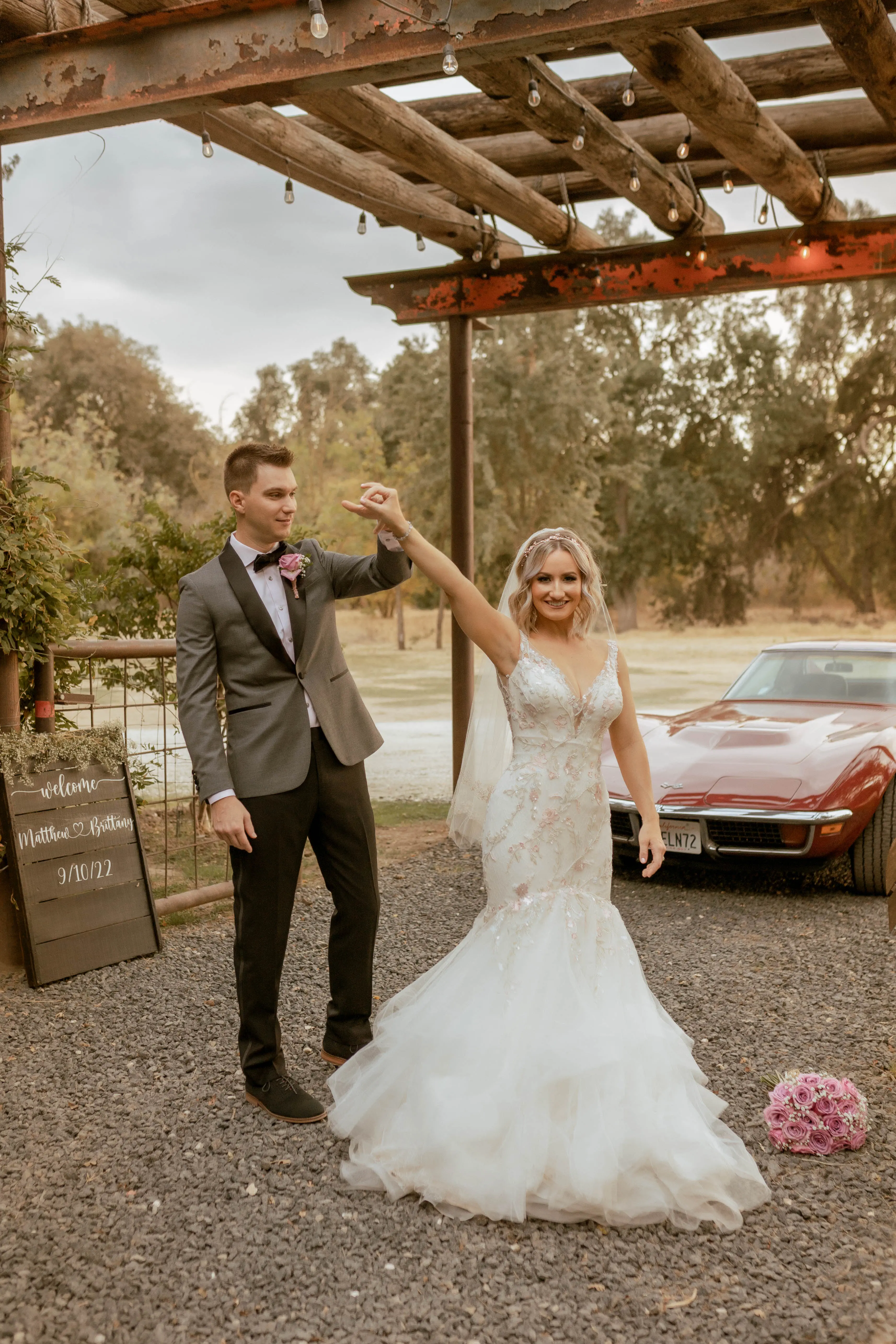 Bride Wearing Pink Lace Mermaid Wedding Dress Called Kenleigh By Sottero And Midgley Holding Hands With Groom