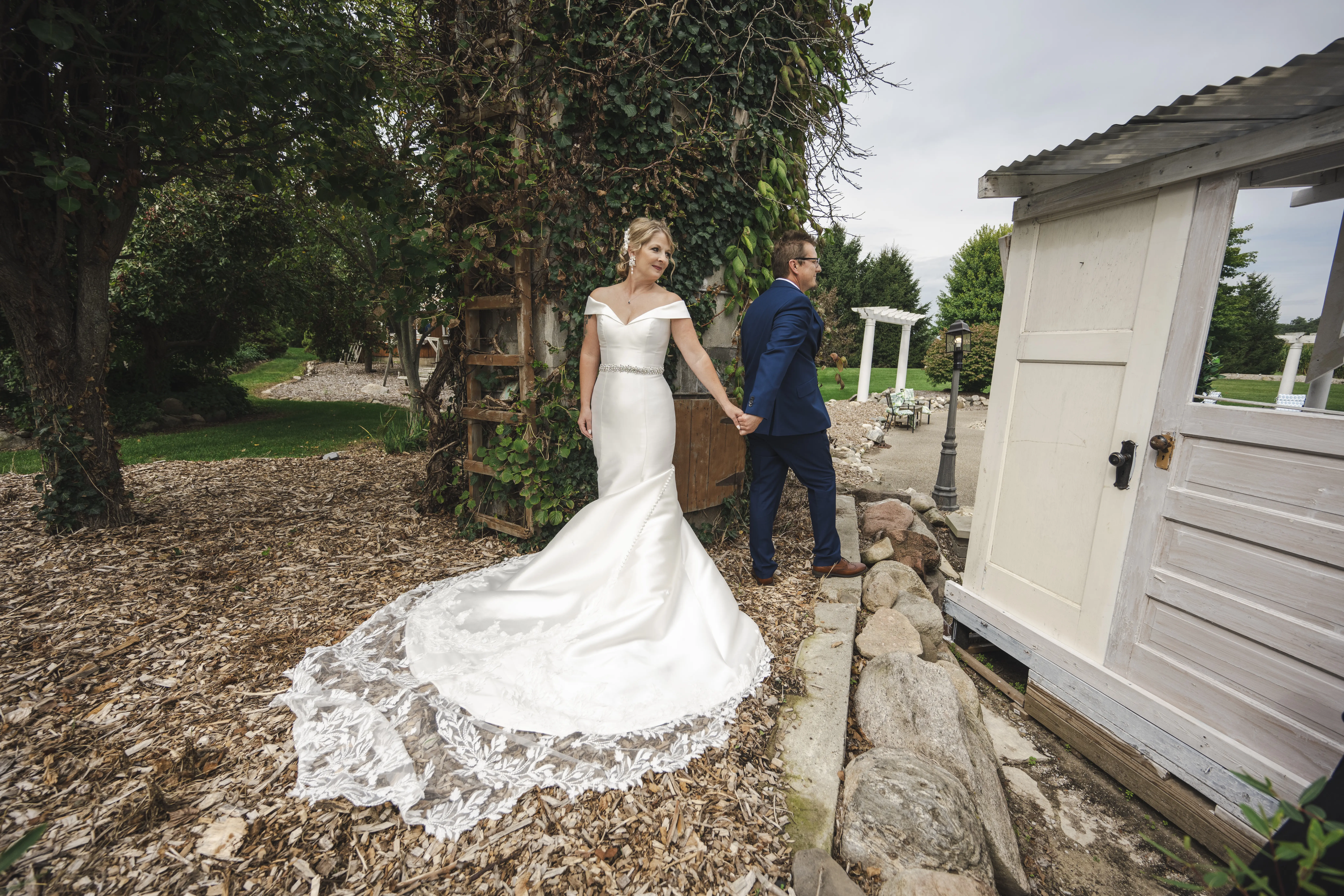 Bride wearing Josie by Rebecca Ingram walking with her husband