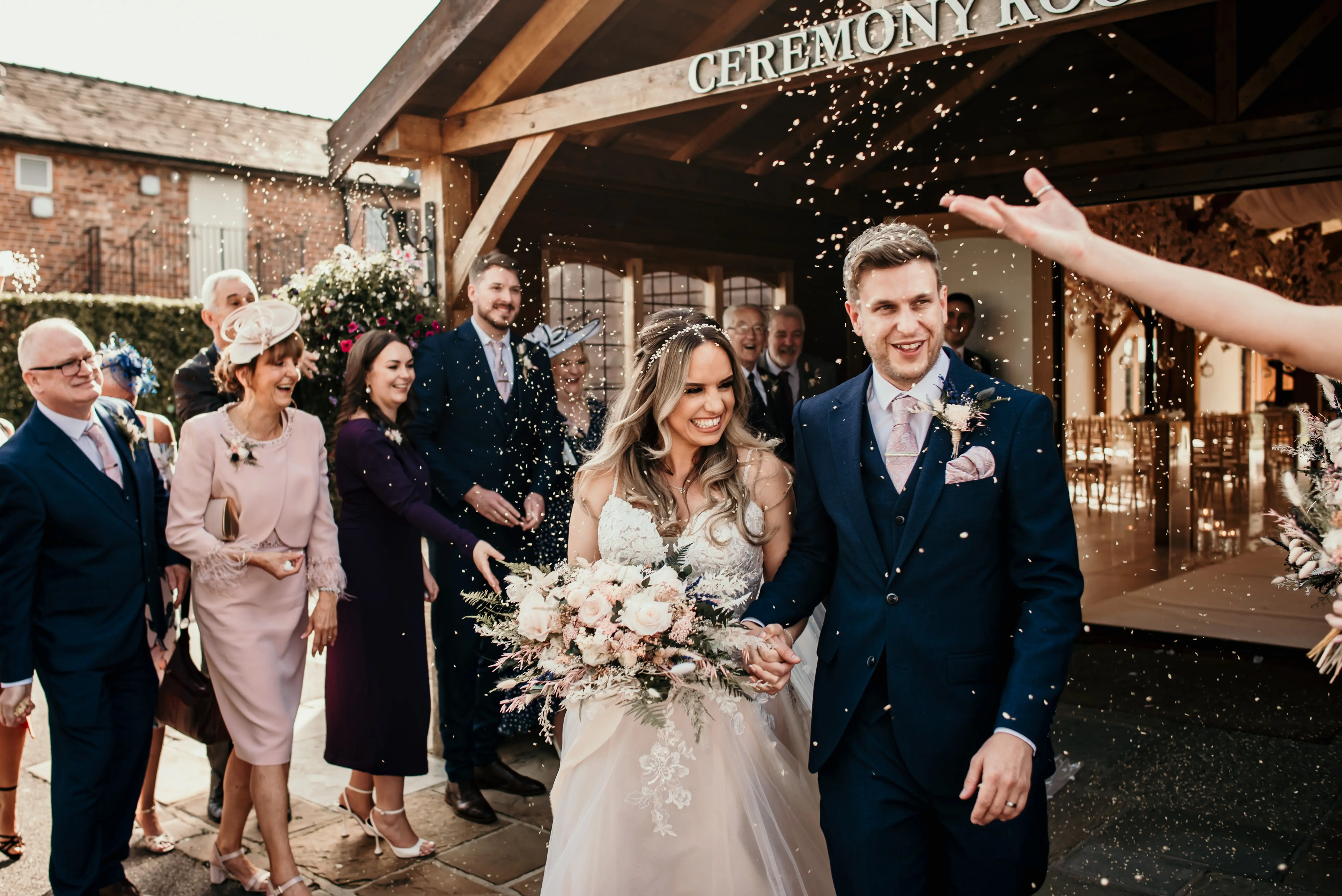 Bride wearing Stevie wedding gown by Maggie Sottero at their exit