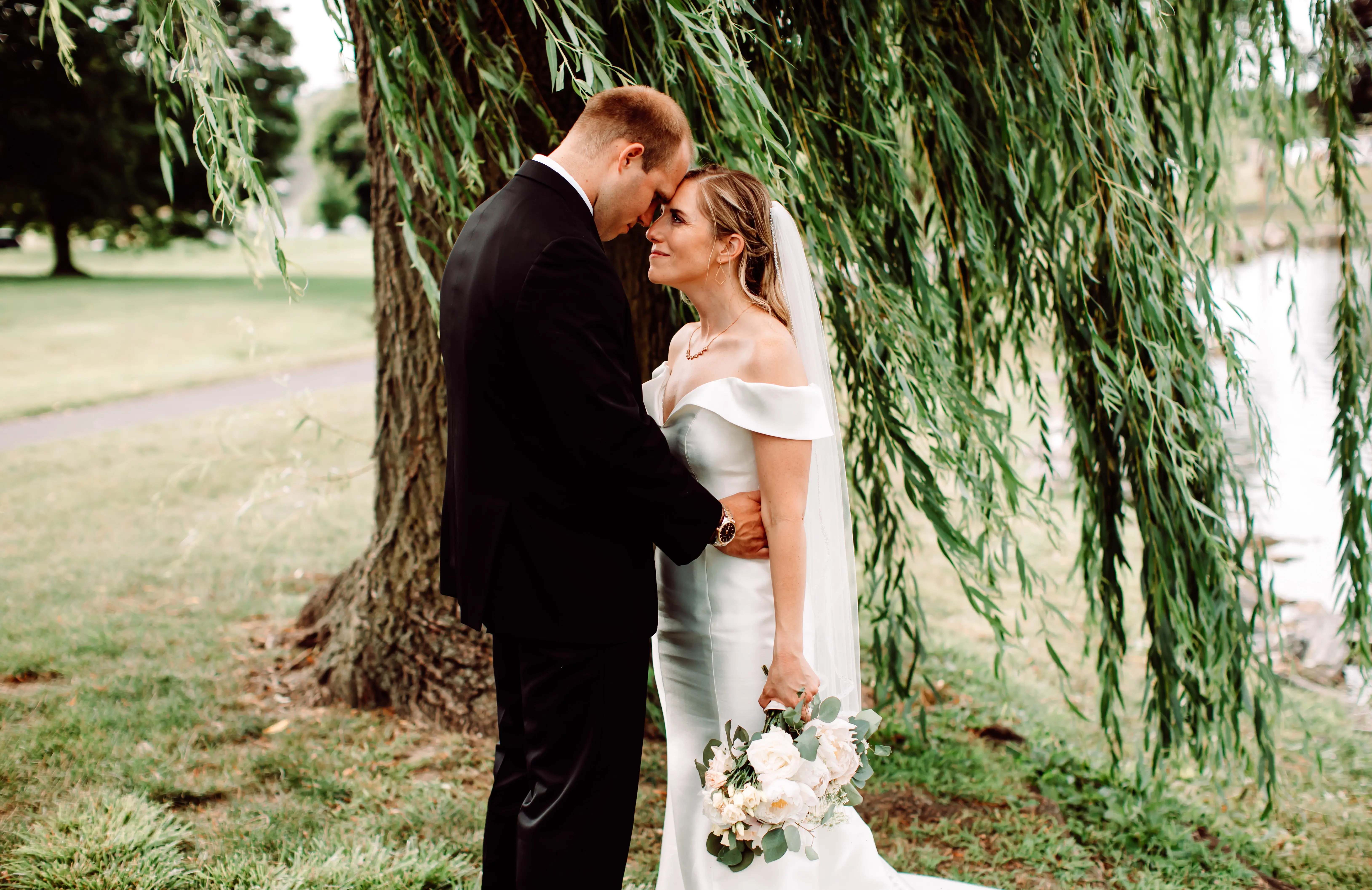 Bride and groom with foreheads touching looking at each other.