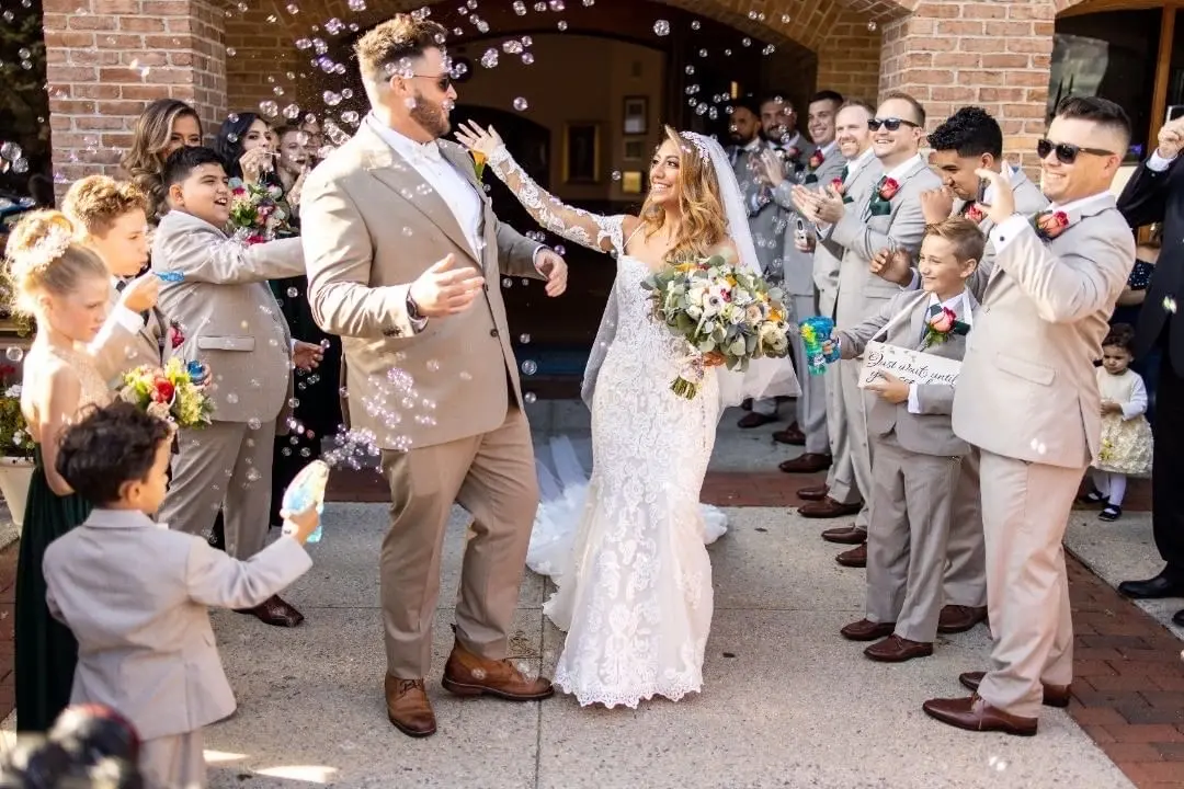Bride Wearing Sparkly Fit-And-Flare Wedding Dress Called Fiona By Maggie Sottero With Groom Sent Off With Bubbles