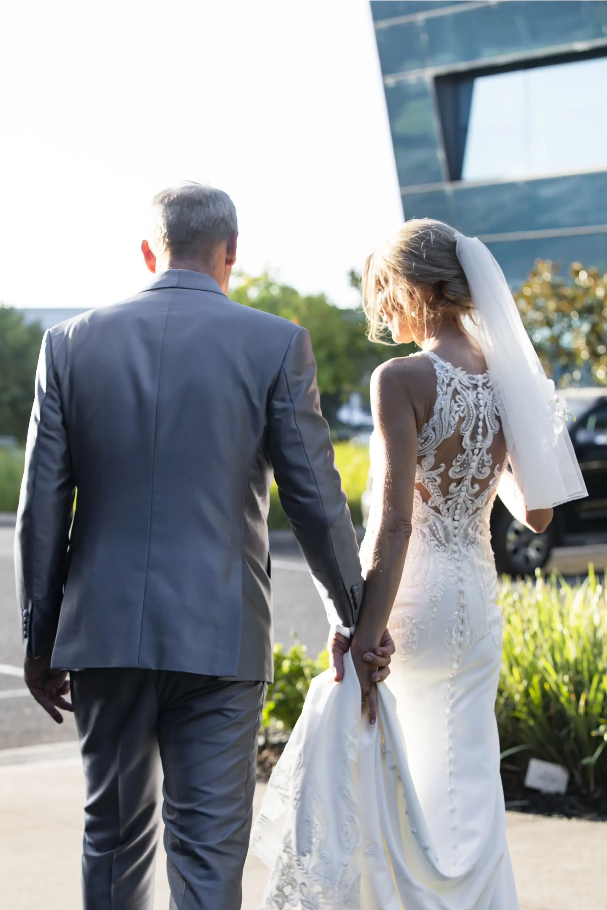 Bride wearing Audrina by Maggie Sottero walking with her husband