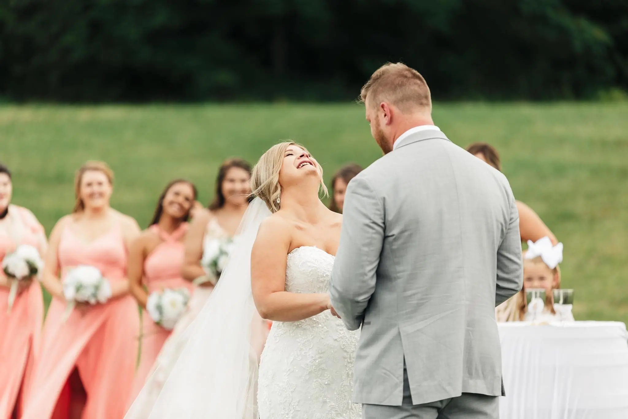 Bride with groom wearing glamorous plus size mermaid wedding dress
