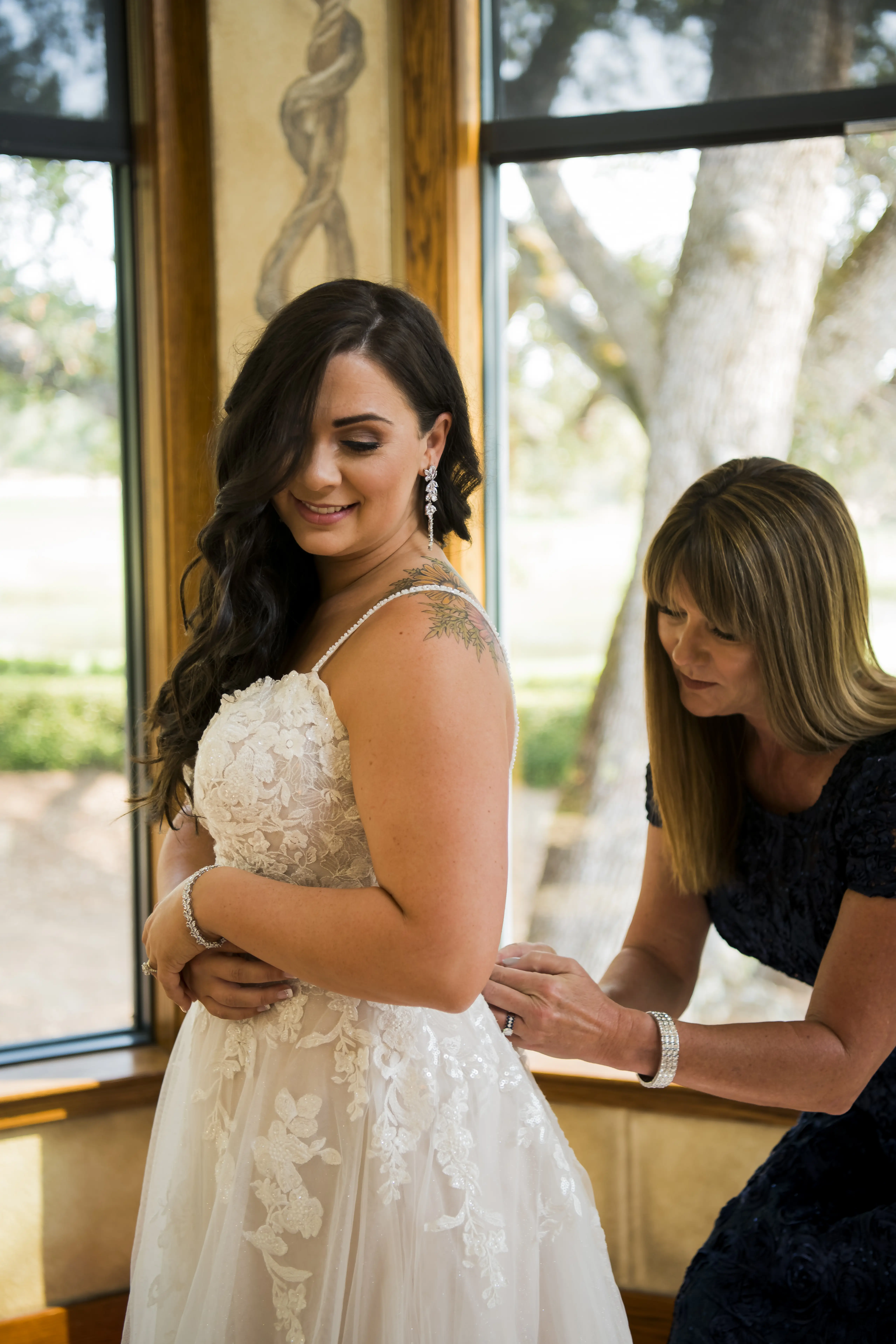 Bride wearing Princess Wedding Gown called Stevie by Maggie Sottero getting ready