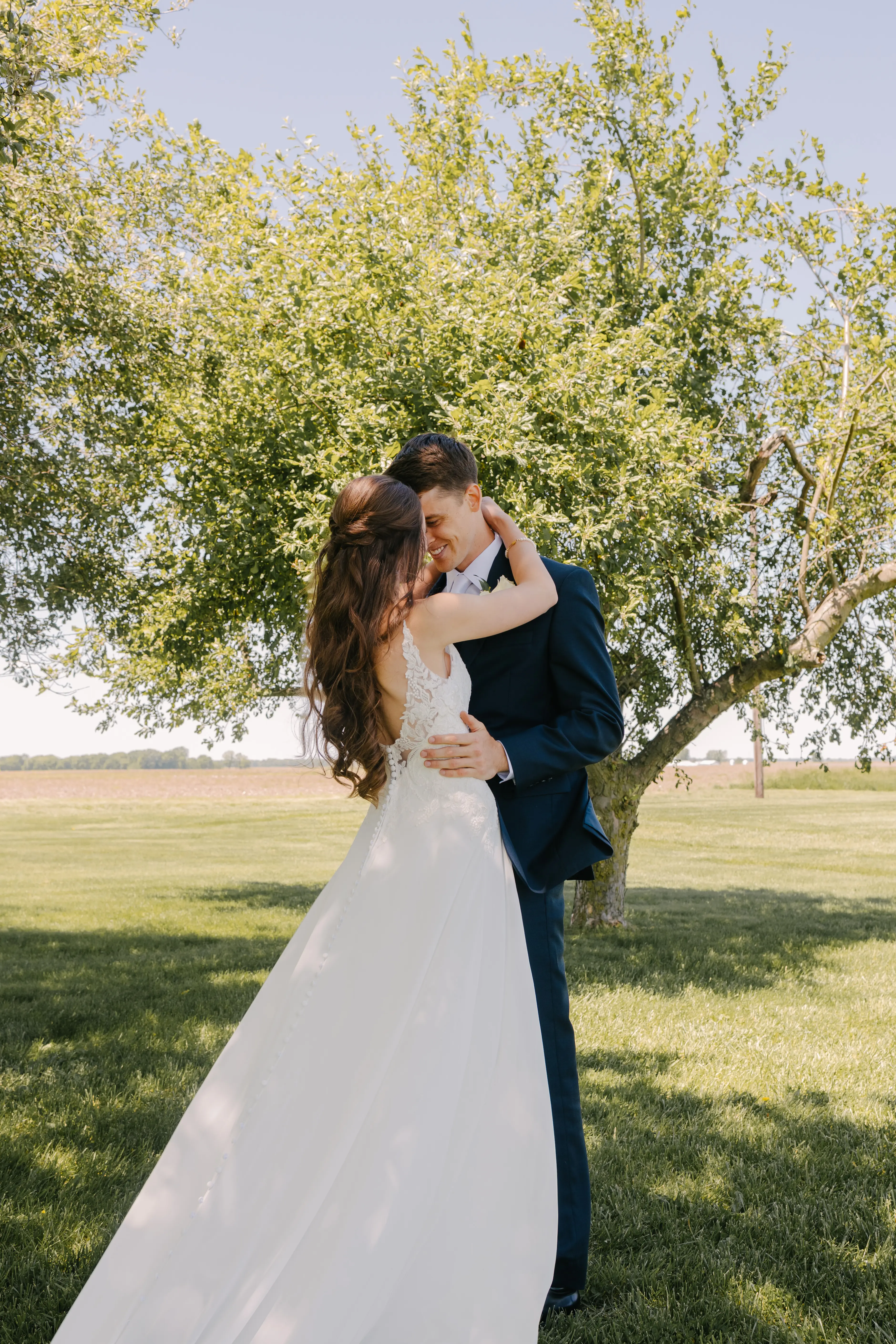 Bride wearing Charlotte by Rebecca Ingram hugging her husband