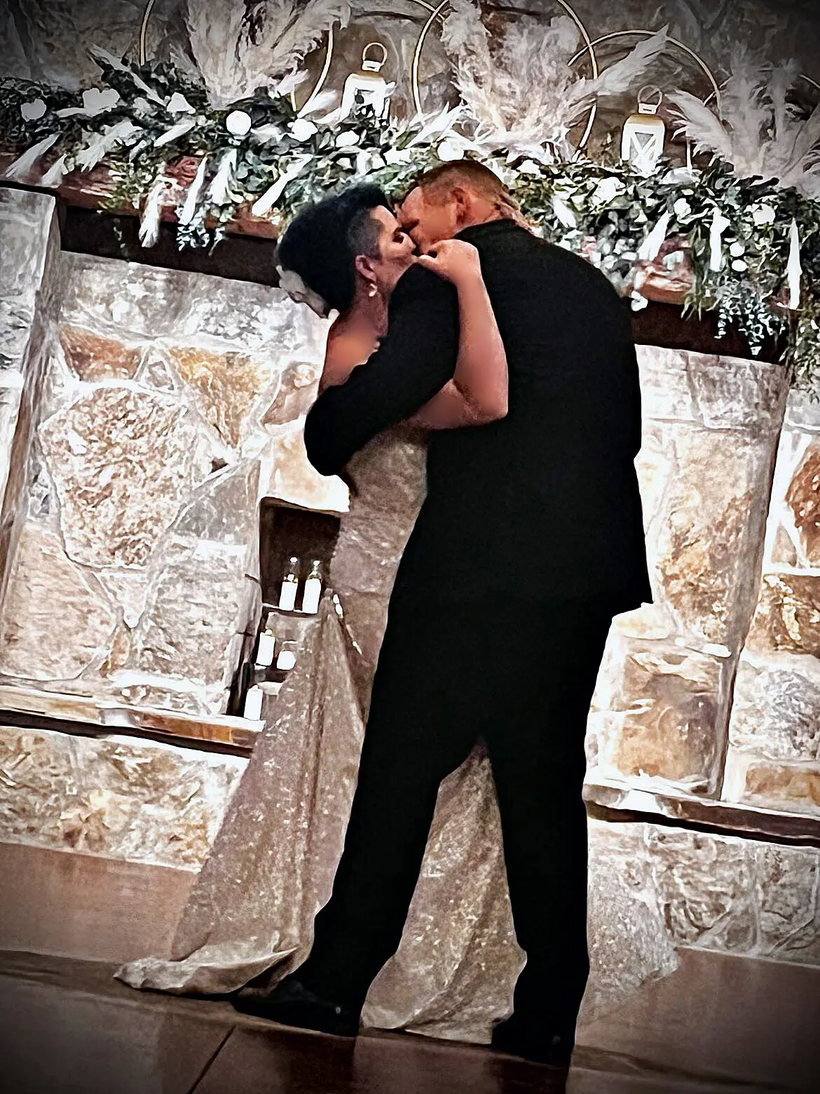 Bride Wearing Sparkly Fit-and-Flare Wedding Dress Kissing Groom
