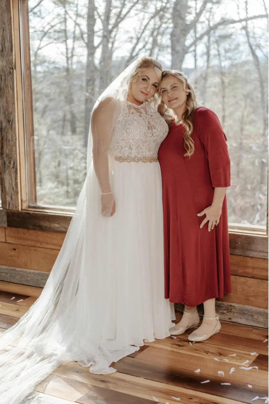 Bride In Chiffon Wedding Dress Called Tasha By Rebecca Ingram With Red And Blue Rose Bouquet And Bridesmaids In Red