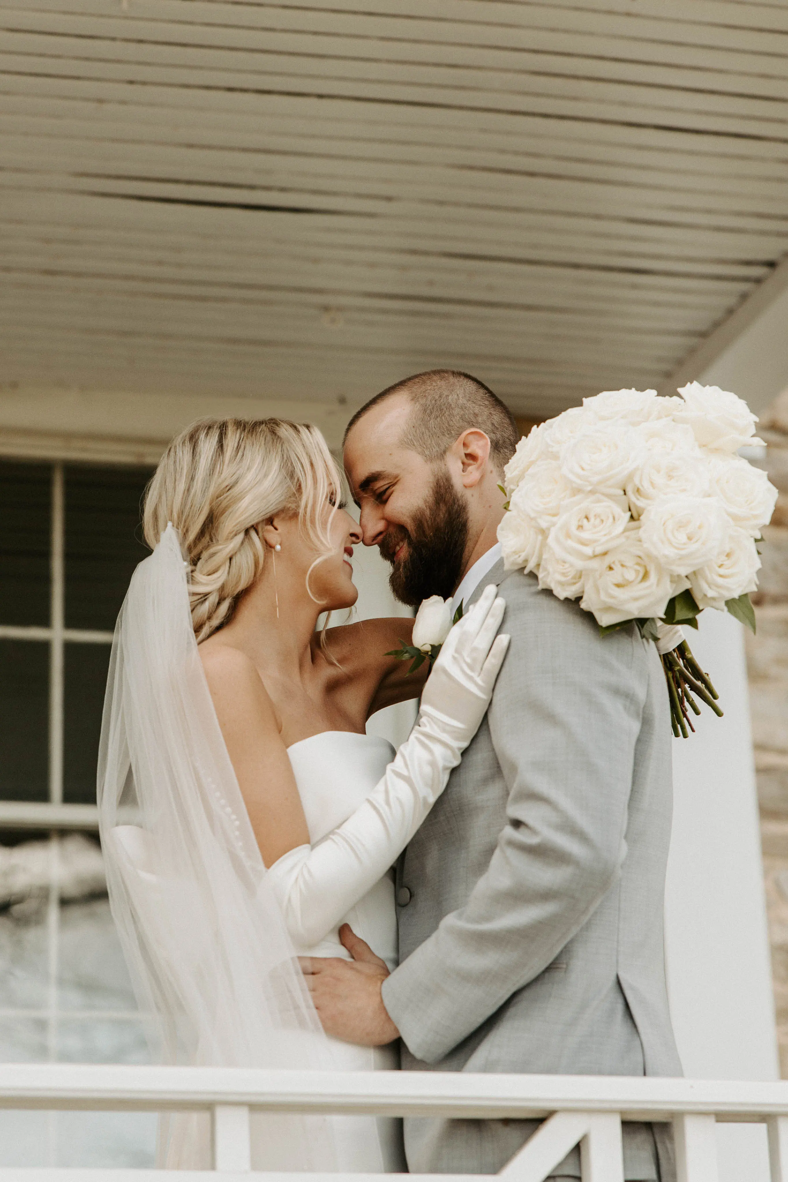 Groom Smiling With Bride In A White Strapless Wedding Dress Named Mitchell By Maggie Sottero