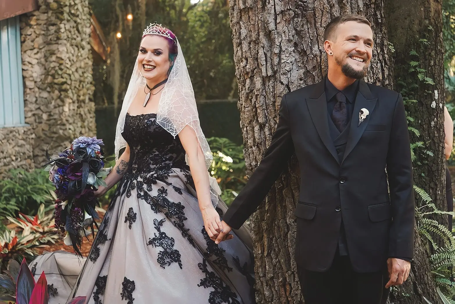 Bride Wearing Black Lace Wedding Dress Called Norvinia By Sottero and Midgley Holding Hands With Groom
