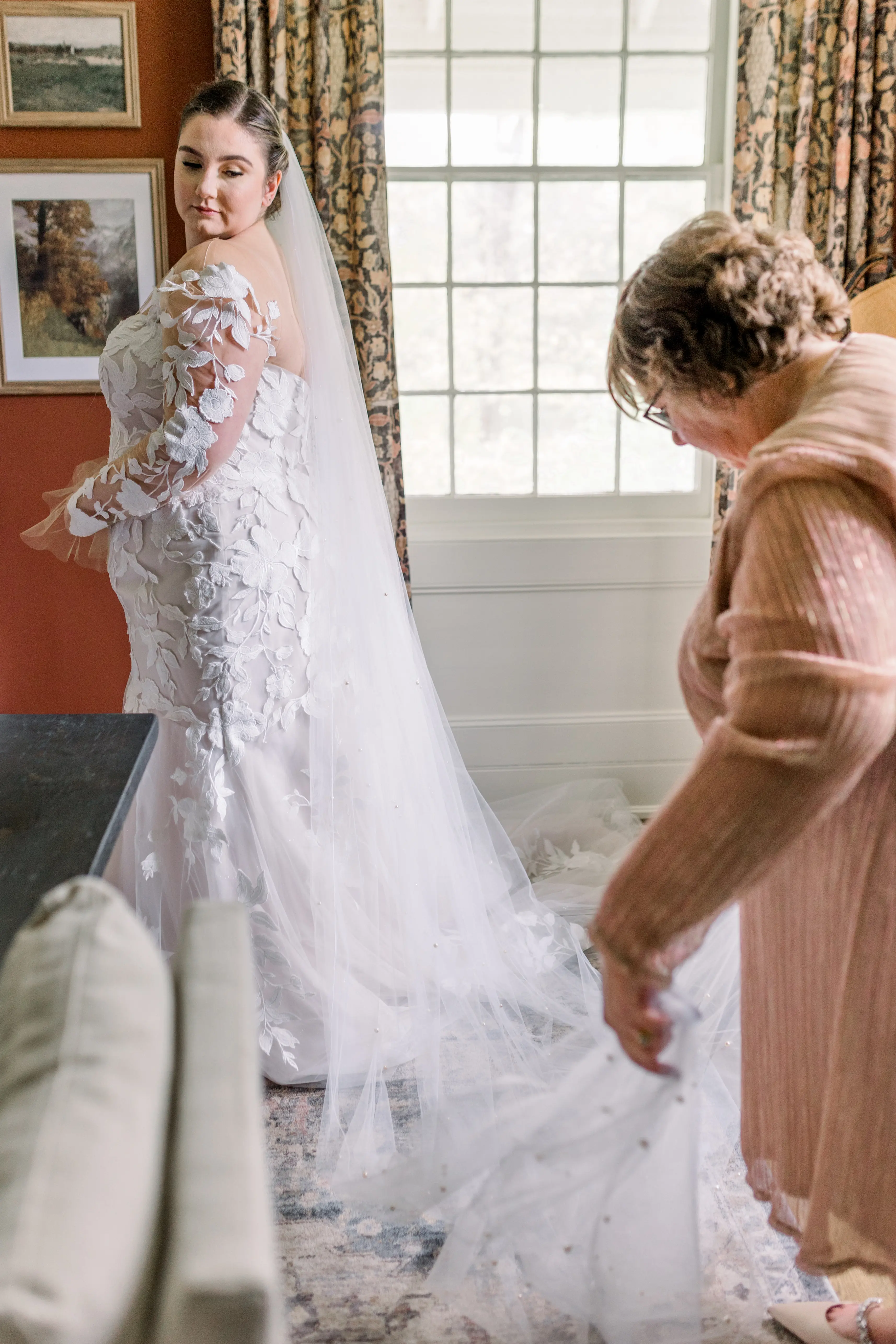 Bride wearing Hattie by Rebecca Ingram with mom adjusting her veil