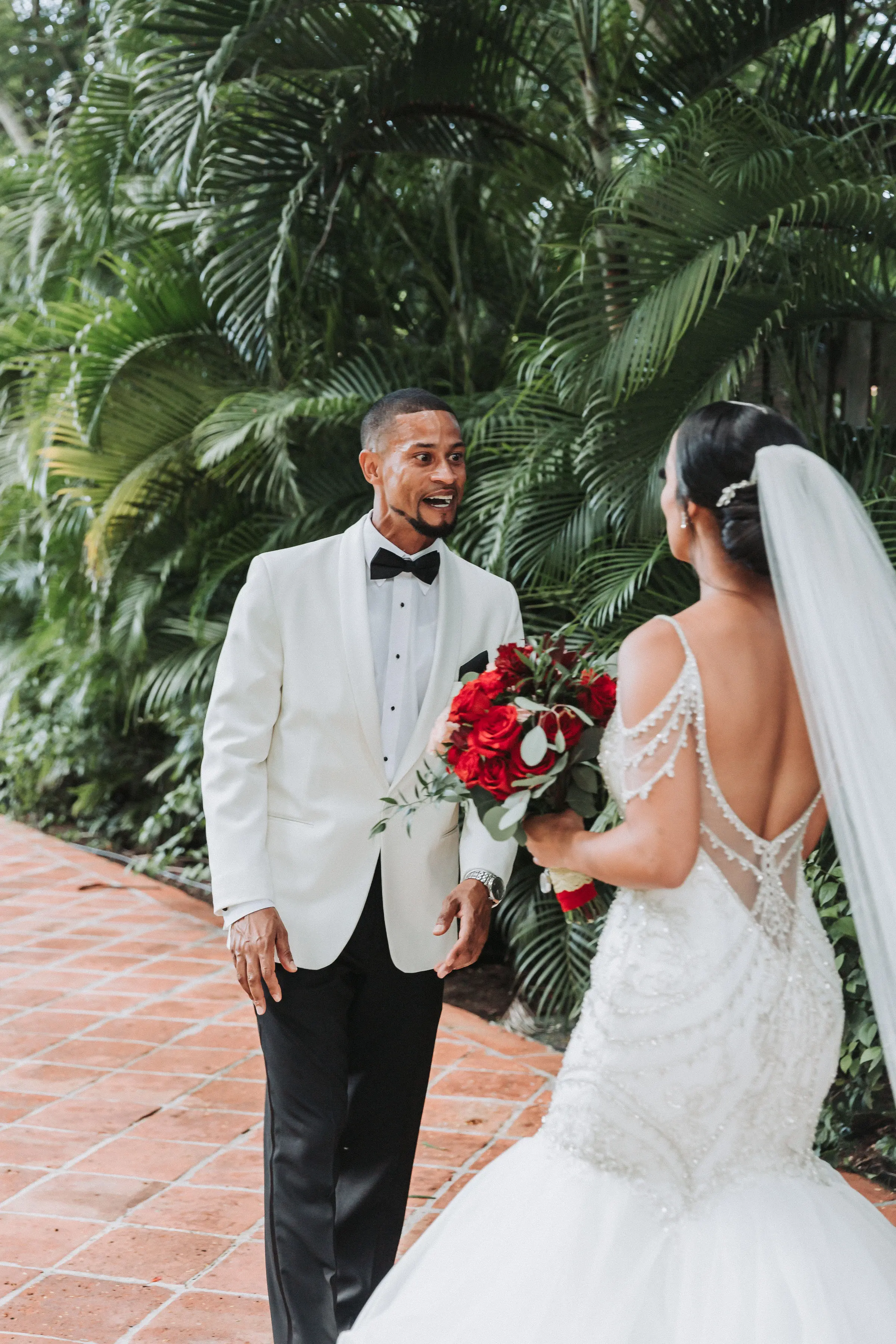 Bride with groom wearing glamorous mermaid wedding dress