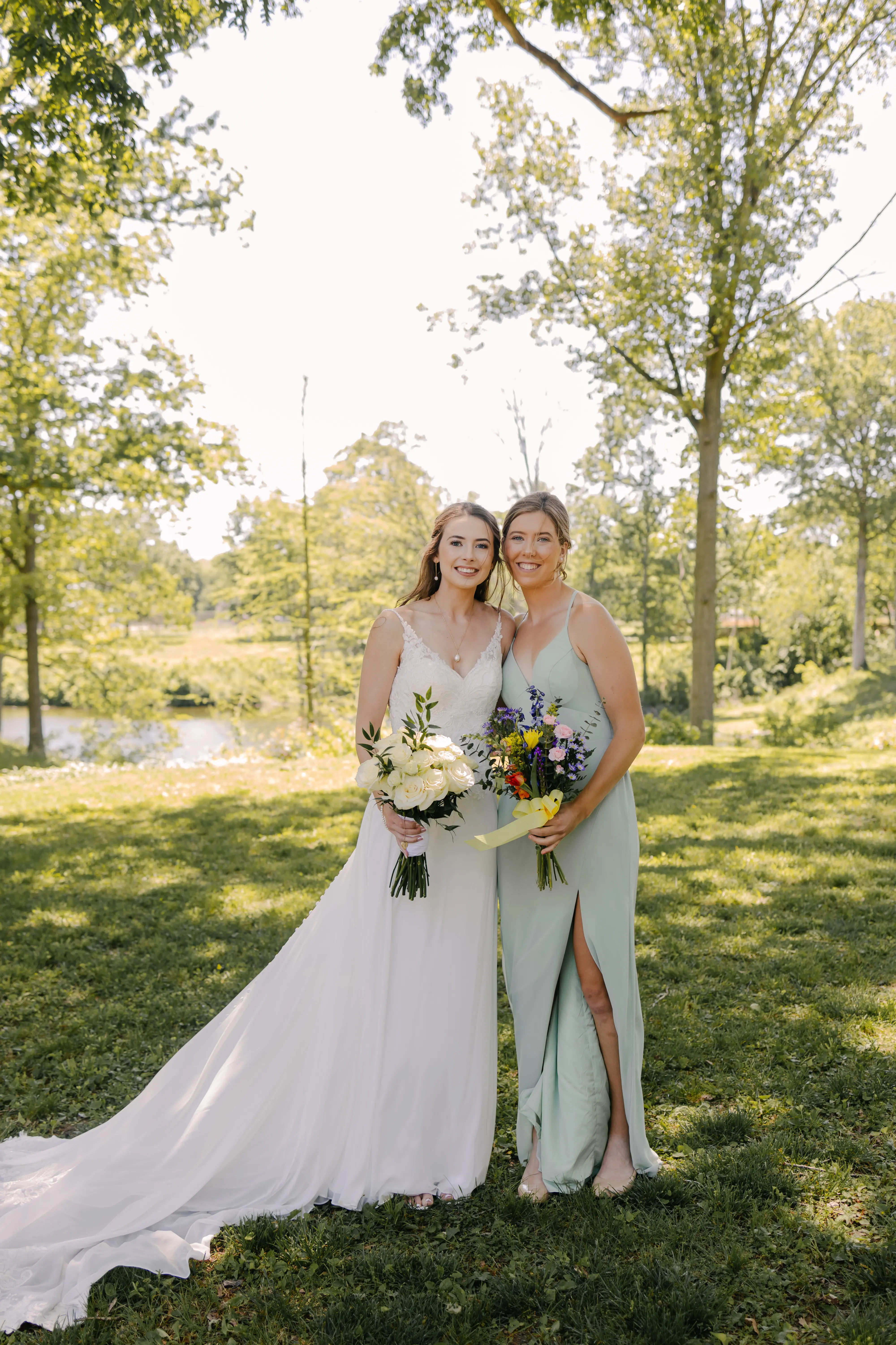 Bride wearing Charlotte by Rebecca Ingram with her bridesmaid