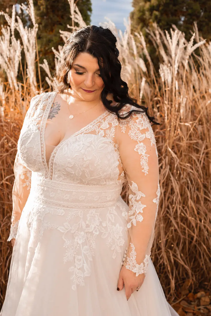 Bride glowing in sunshine wearing wedding dress called Raphael.