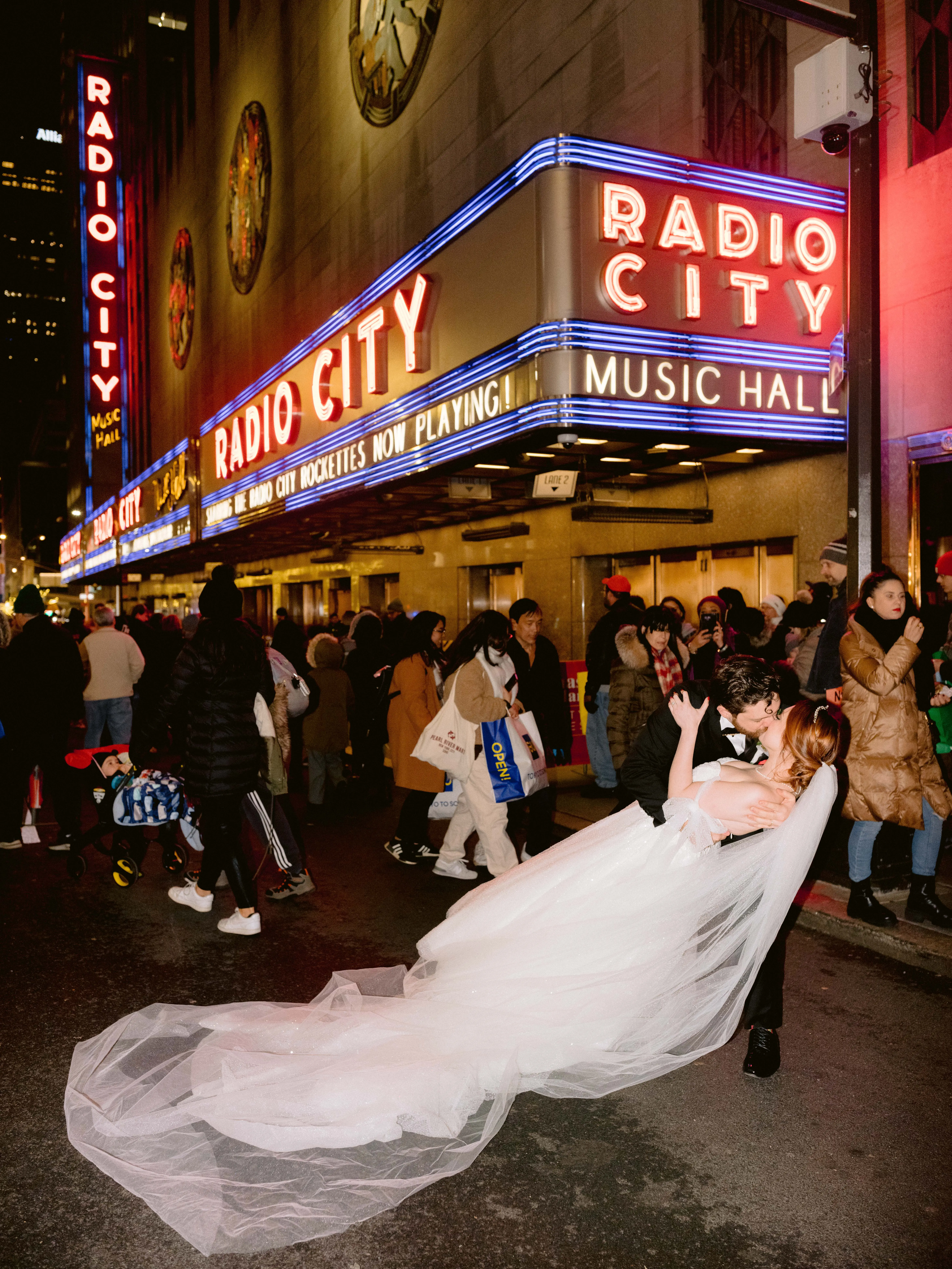 Bride Wearing Princess Ballgown Wedding Dress called Shasta by Sottero and Midgley Kissing The Groom In NYC