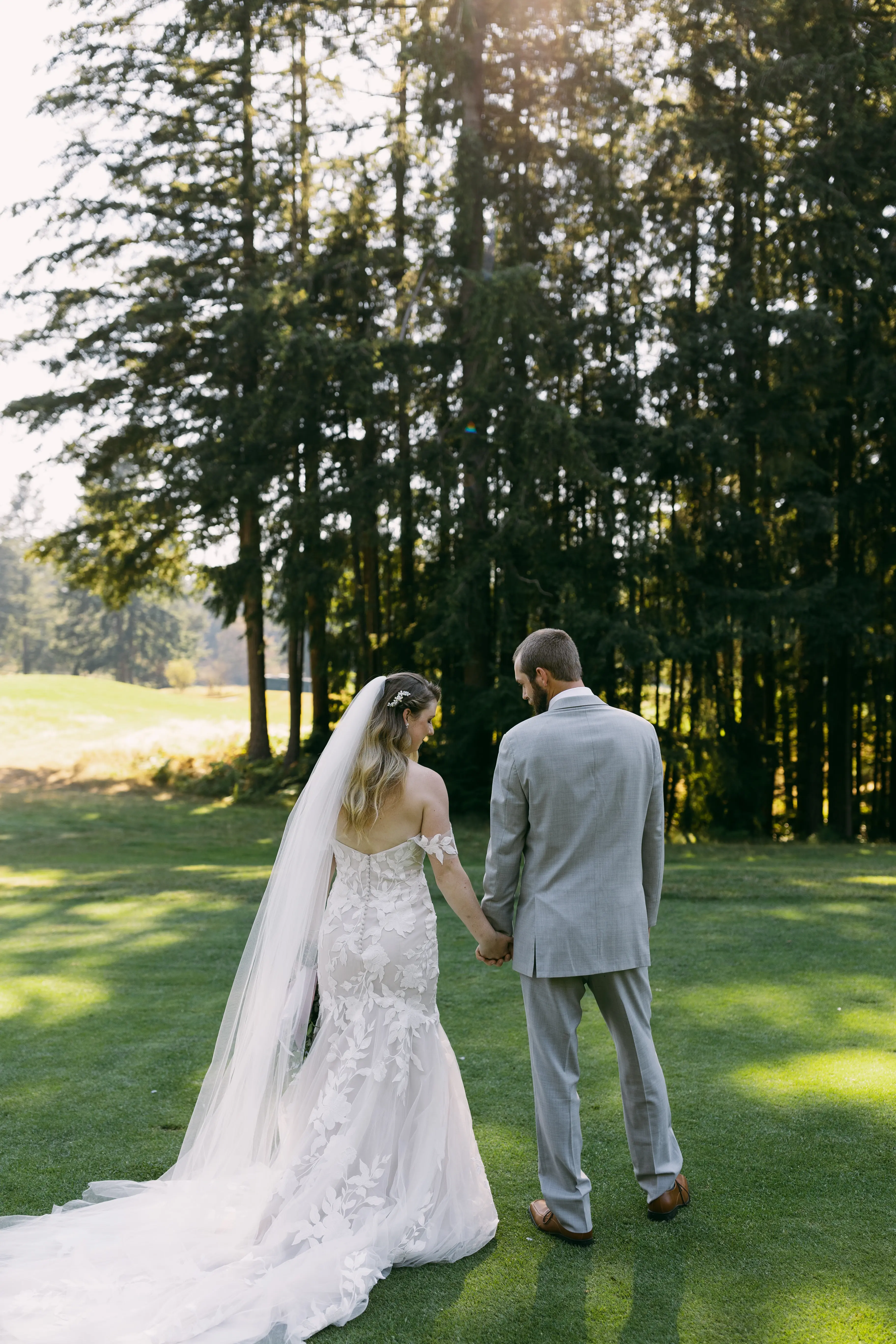 Bride in Strapless Mermaid Wedding Dress Named Hattie By Rebecca Ingram Bride Holding Grooms Hand