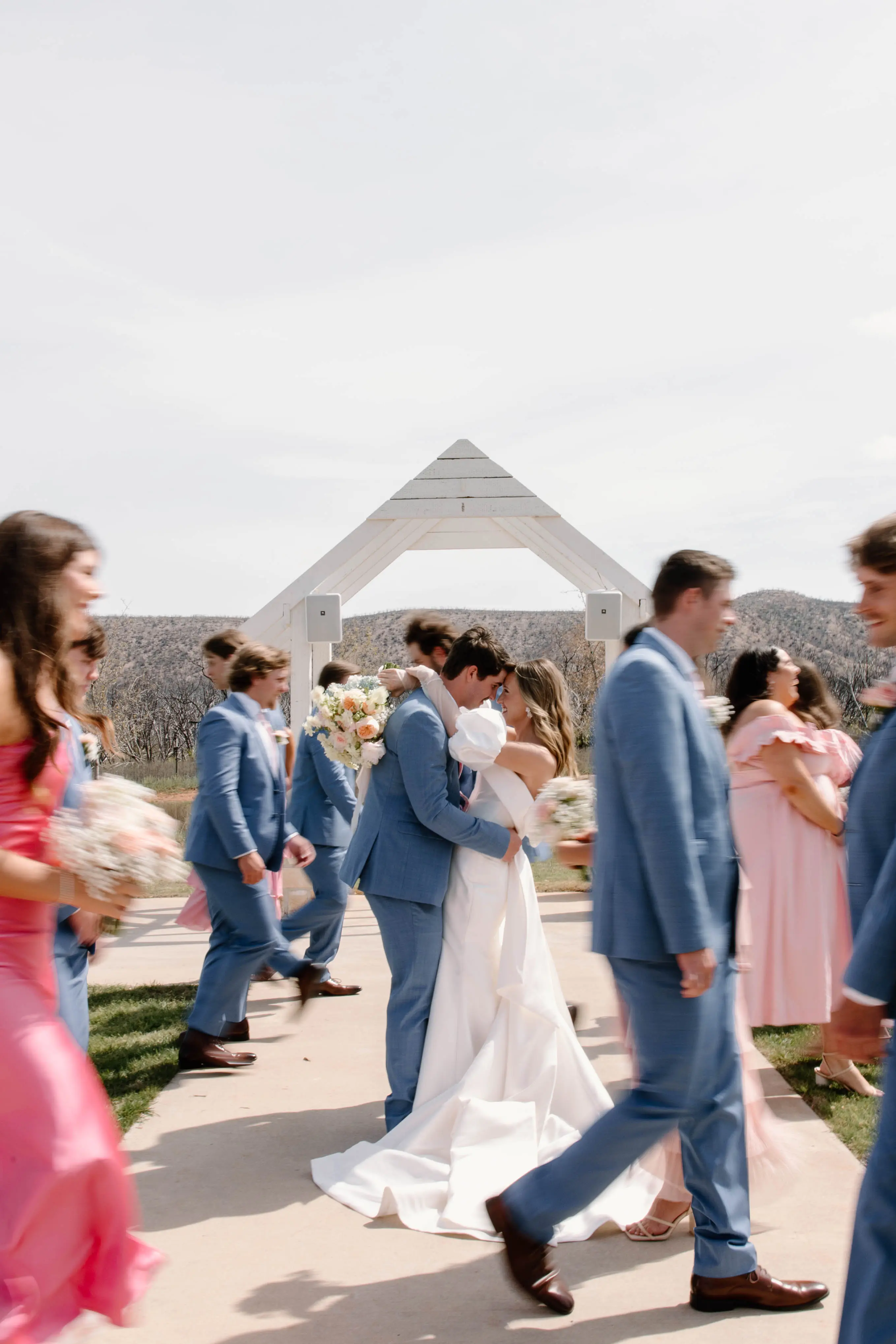 Bride wearing Mitchell by Maggie Sottero with her husband