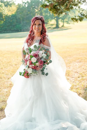 Bride Wearing Sparkly Princess Ballgown Wedding Dress Called Yasmin By Maggie Sottero Holding A Pink Purple And White Bouquet