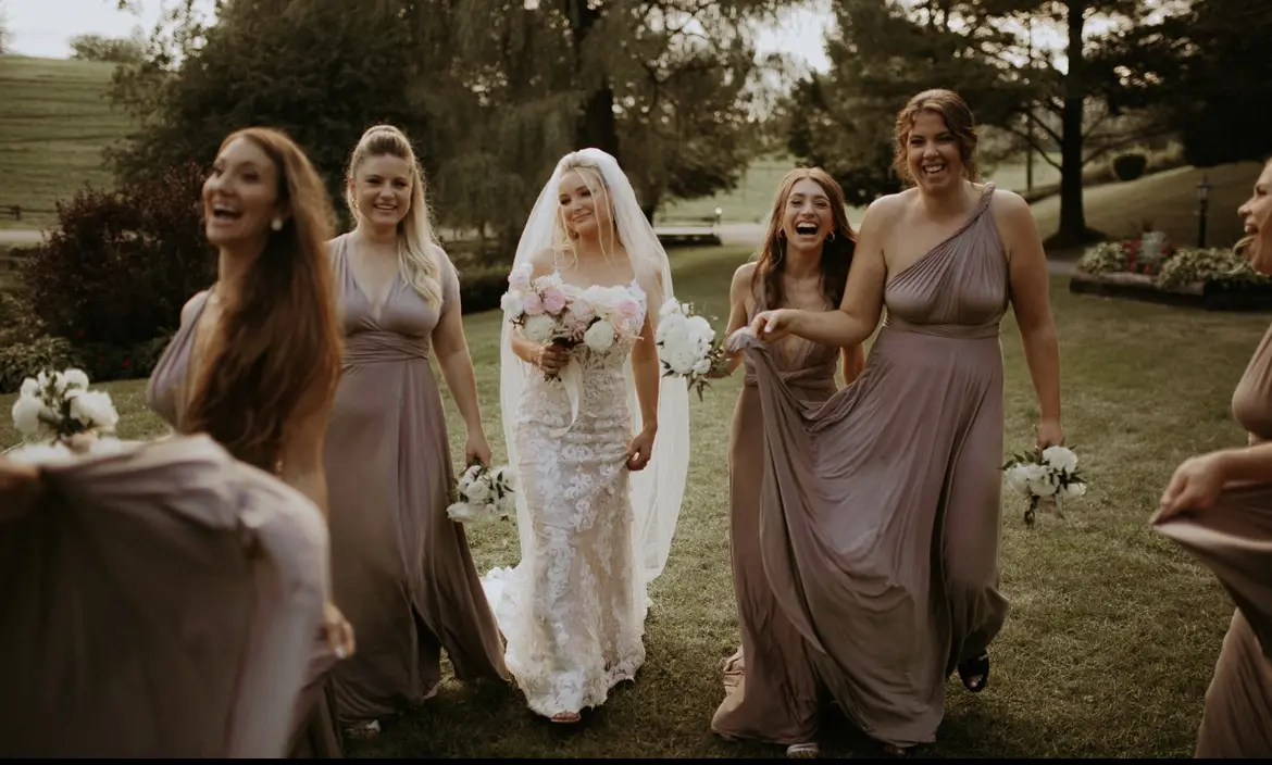 Bride wearing Lace Fit-and-Flare Wedding Dress called Tuscany Lynette by Maggie Sottero with her bridesmaids