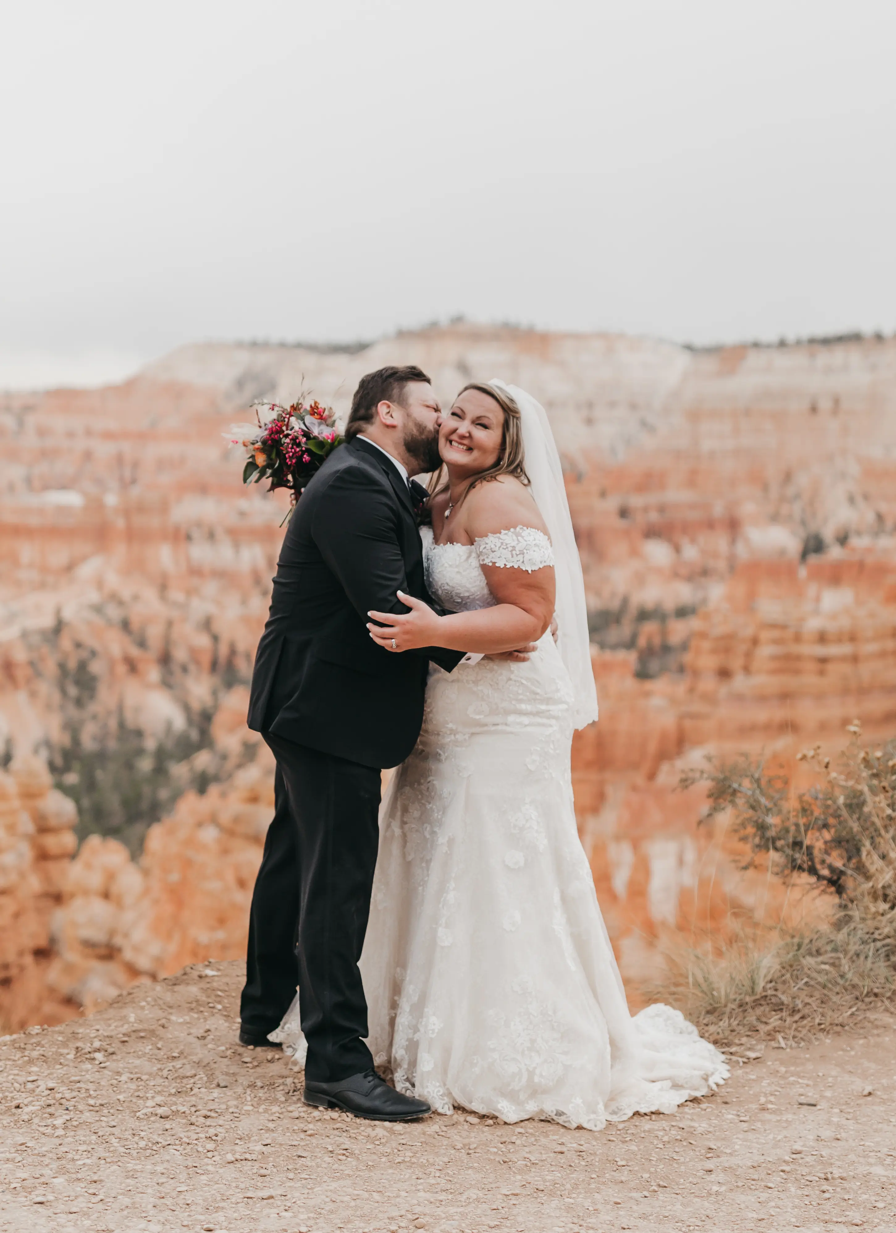 bride with groom in corset back fit and flare wedding dress
