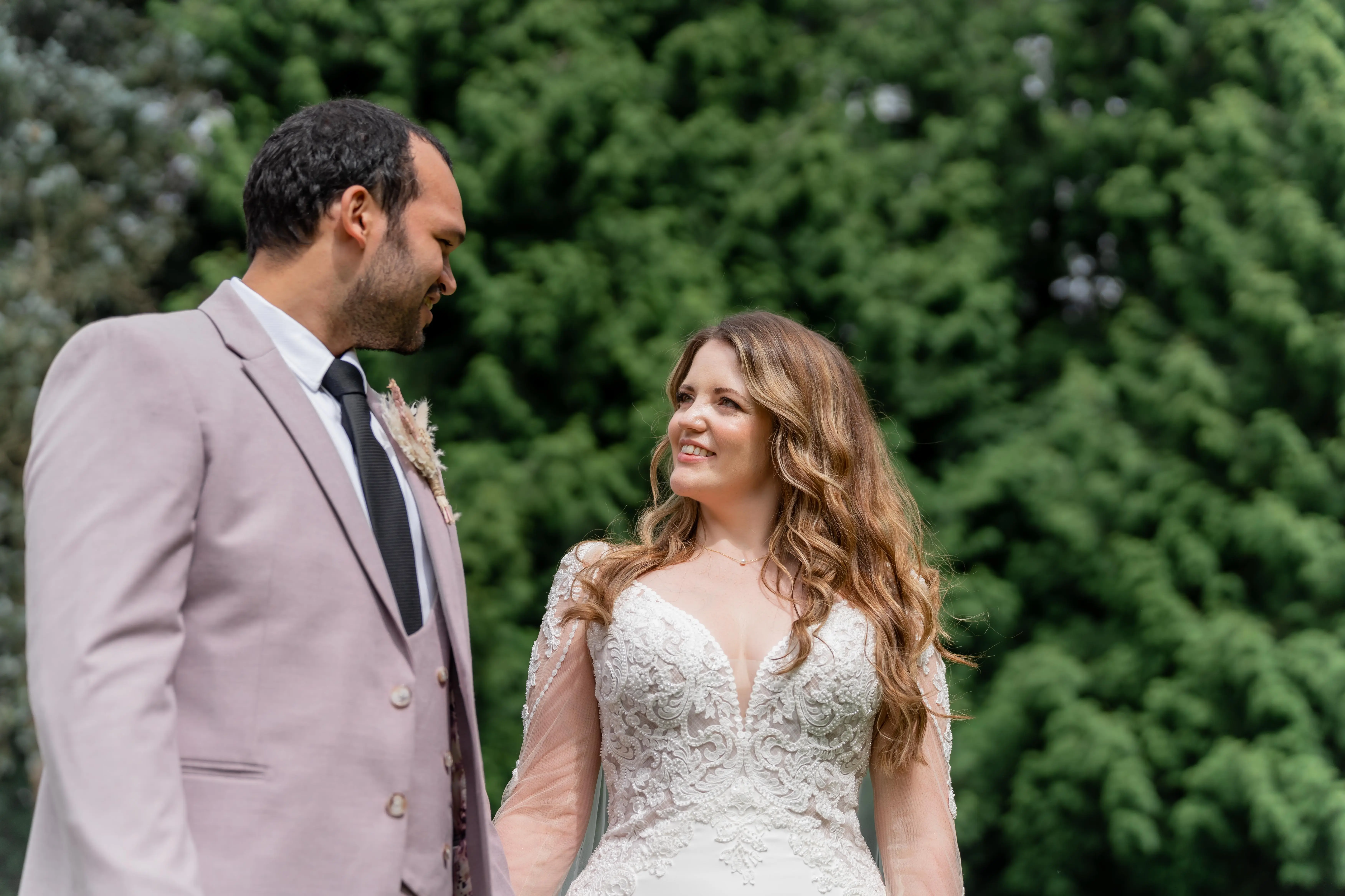 Bride wearing Nikki by Maggie Sottero looking at her husband