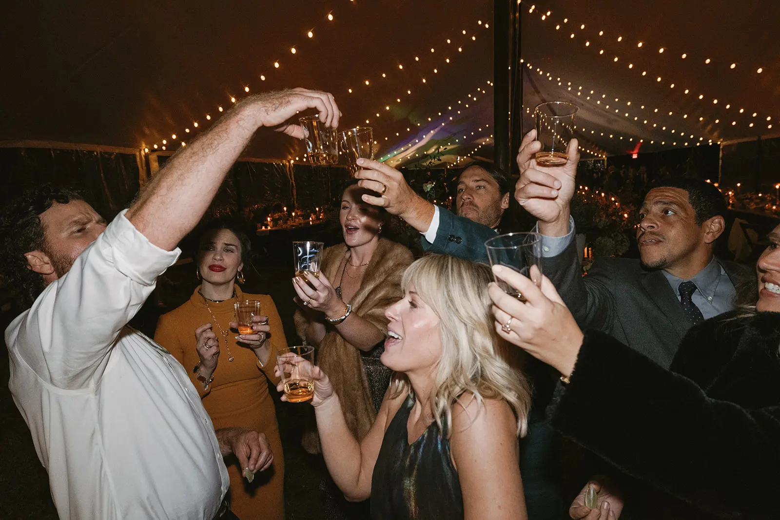 Guests drinking and dancing at reception