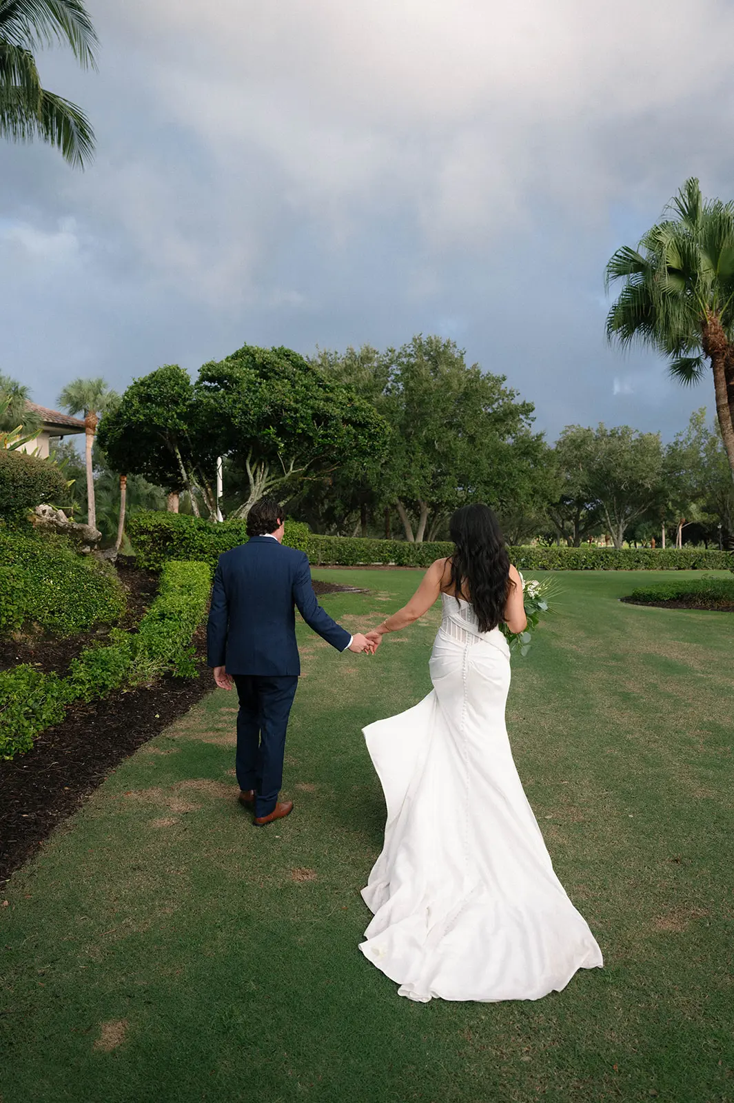 Bride Wearing Grecian Inspired Wedding Dress Called Gabrielle By Maggie Sottero Holding Hands With Groom