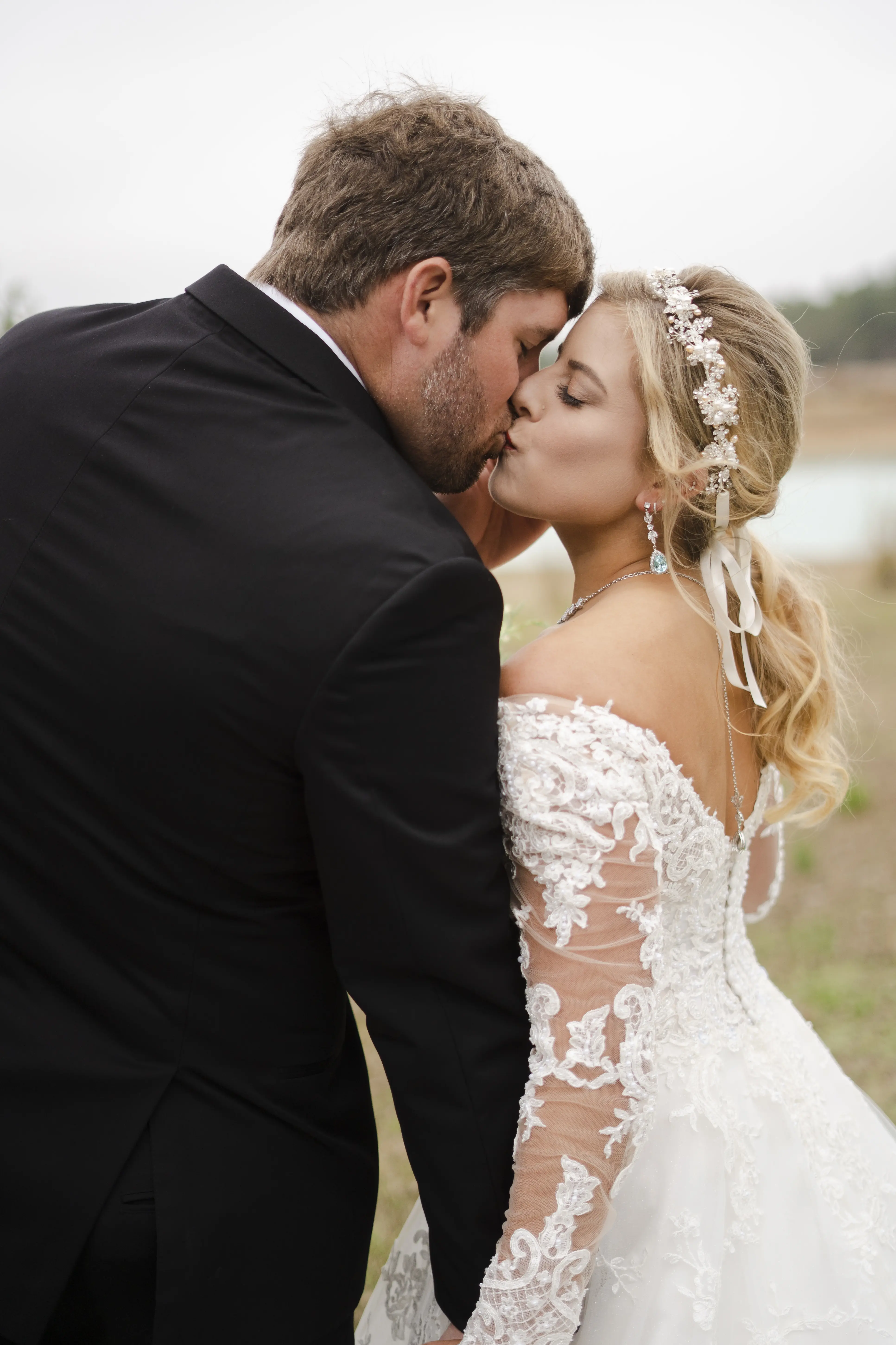 Bride In Off The Shoulder Lace Wedding Dress Called Tiffany By Maggie Sottero With Groom