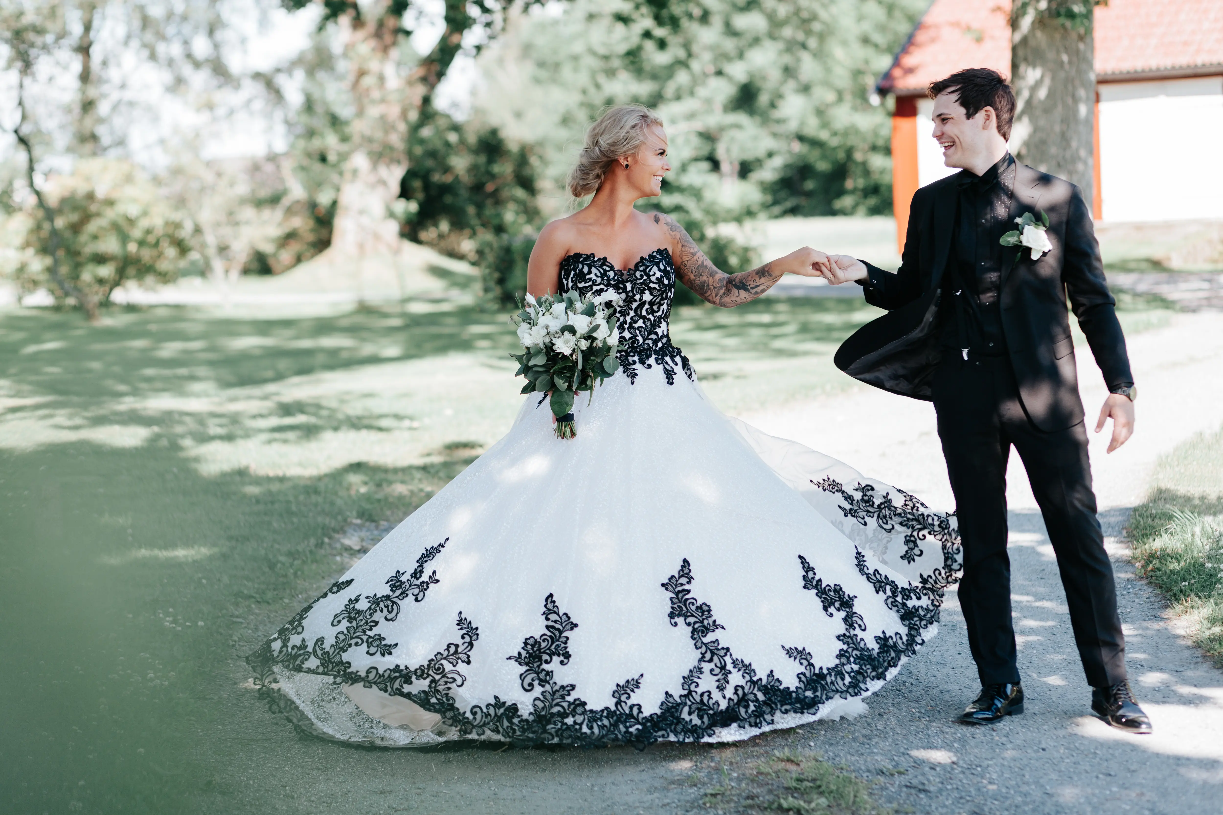 Groom With Bride Wearing Ballgown With Black Lace Detail Called Tristyn By Maggie Sottero