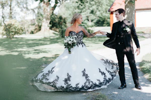 Groom With Bride Wearing Ballgown With Black Lace Detail Called Tristyn By Maggie Sottero