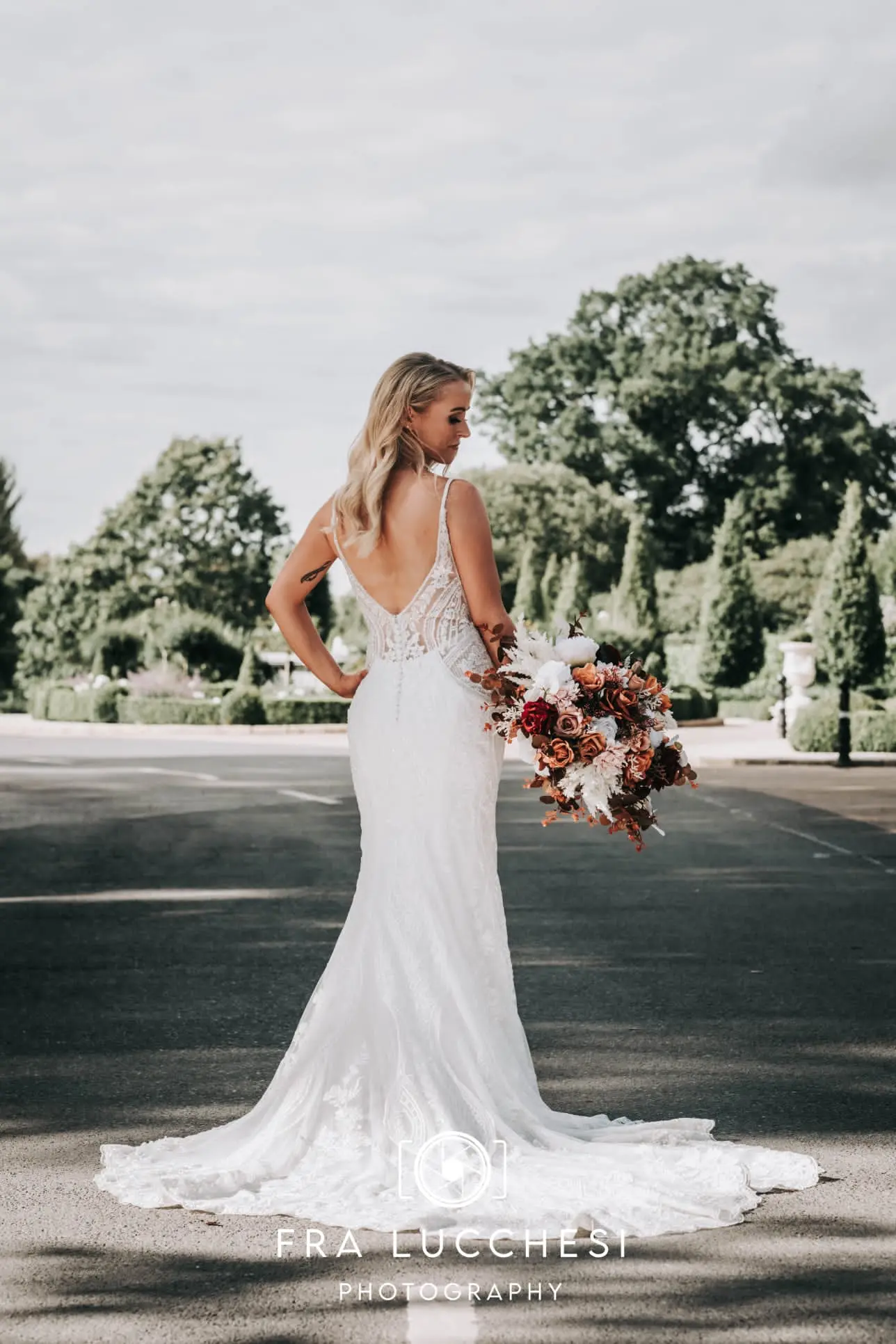Bride wearing Bailey wedding dress by Sottero and Midgley showing off the back of her dress