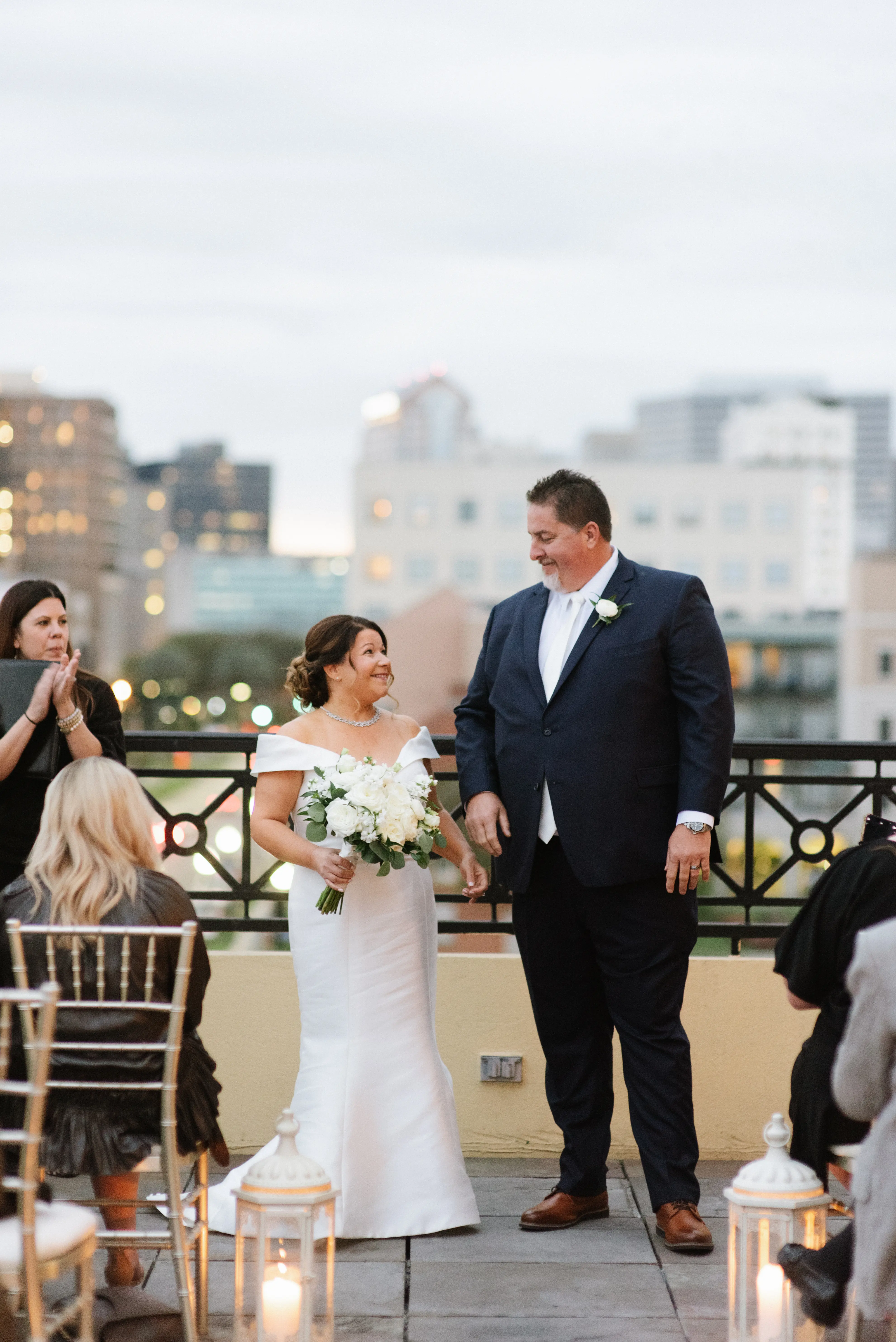 Bride with groom wearing elegant off the shoulder wedding dress
