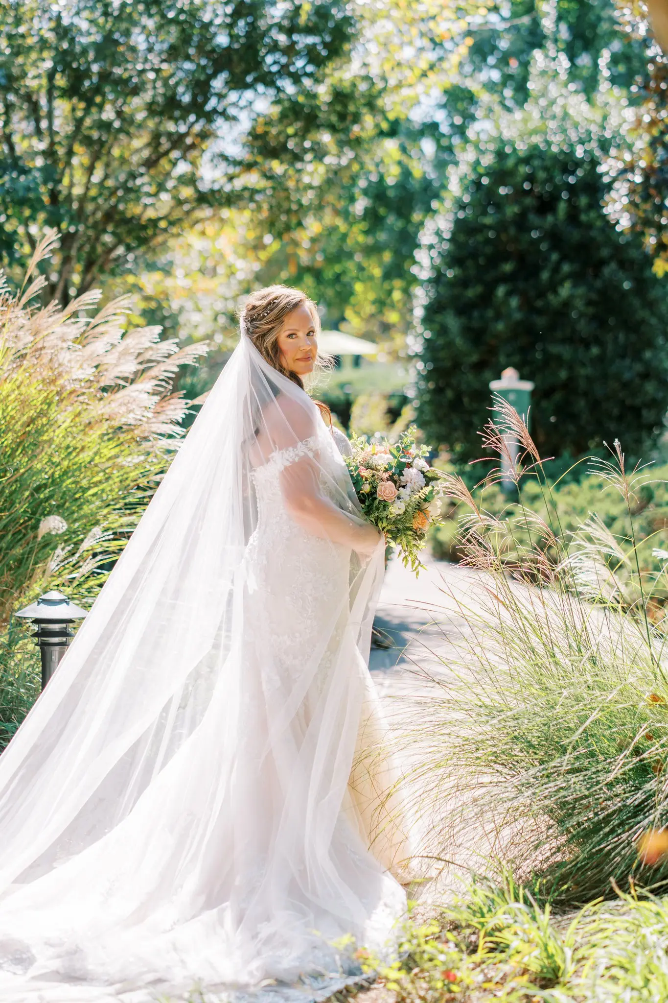Bride Wearing Sexy Lace Wedding Dress Called Lennon By Maggie Sottero Walking Through A Garden