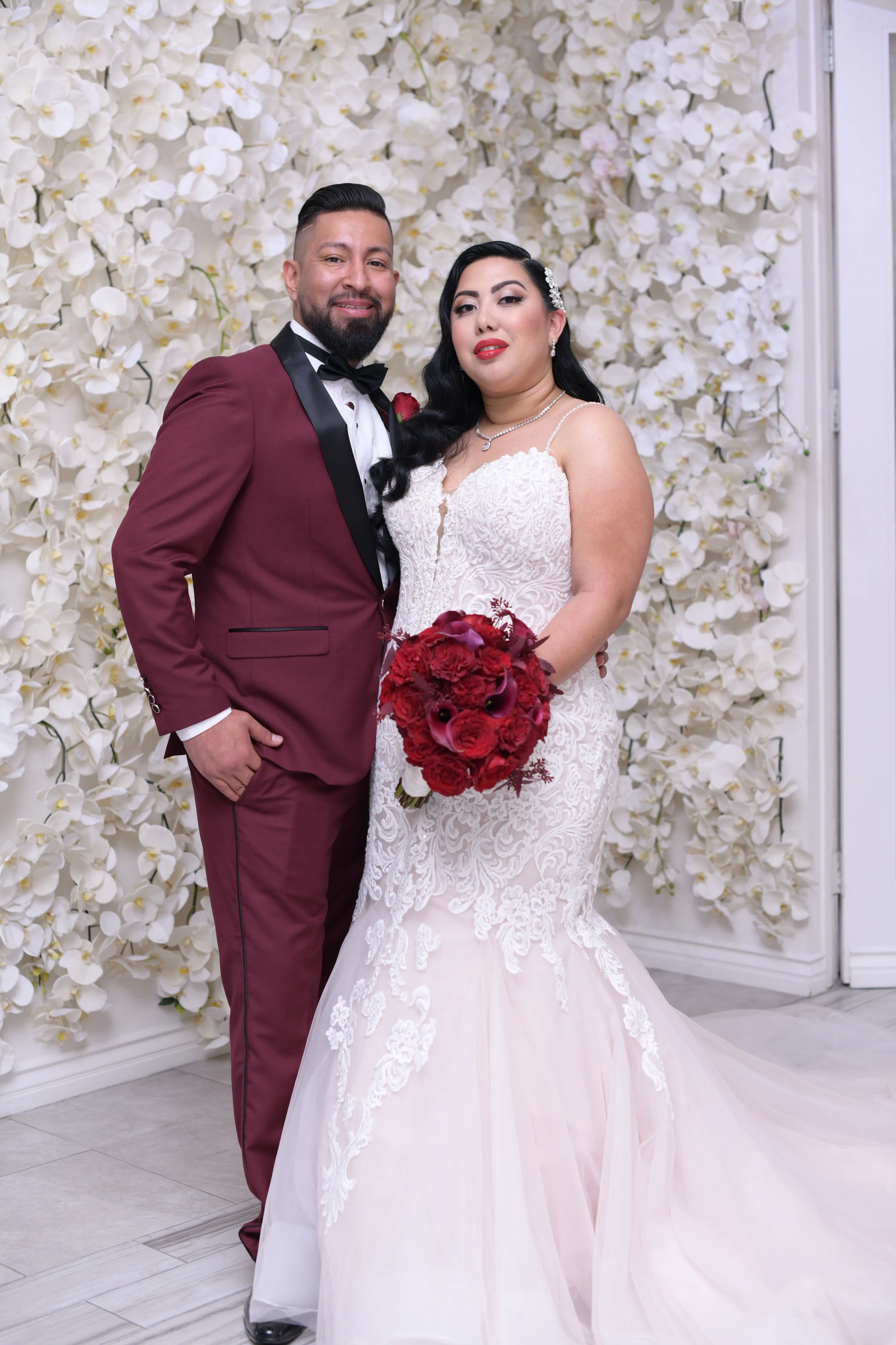 Groom stood with bride wearing wedding dress called Alistaire Lynette.
