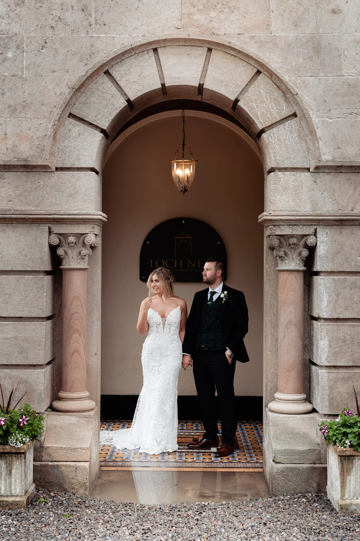 Groom with Bride in Romantic Lace Sheath Wedding Gown with Shimmering Lace Motifs Called Tuscany Lynette by Maggie Sottero