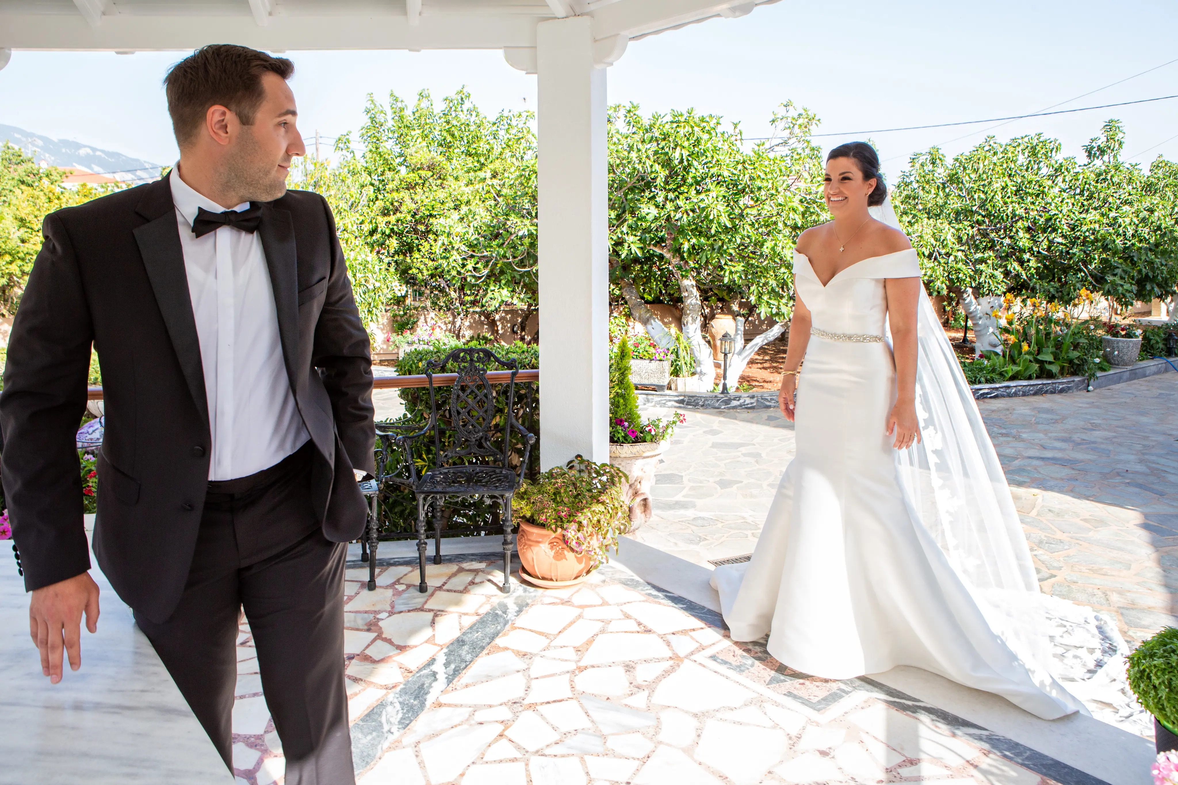 Bride wearing Simple Fit-and-Flare Wedding Dress called Josie by Rebecca Ingram doing a first look with the bride