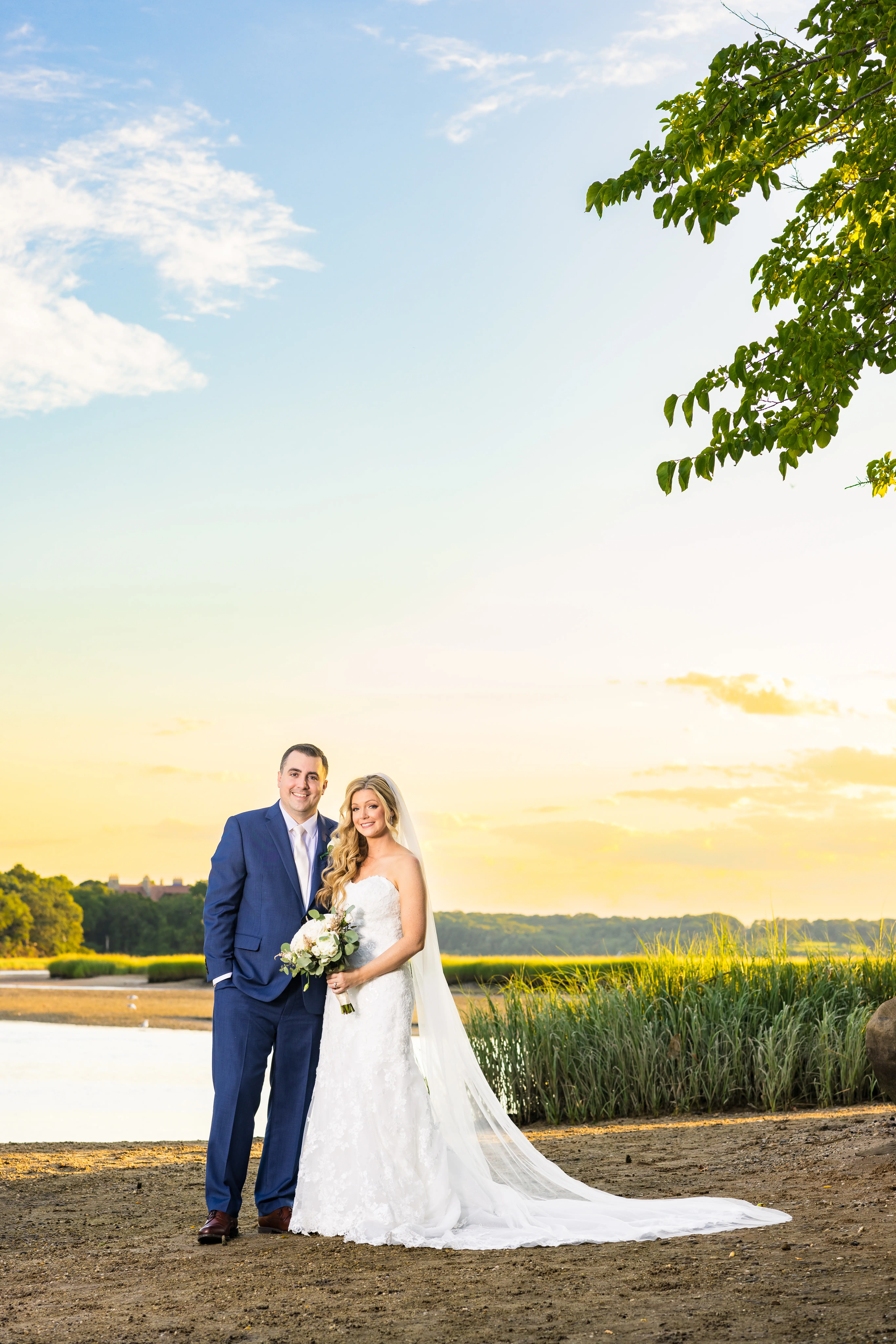 Bride Wearing 3-D Flower Fit-And-Flare Bridal Gown Named Ryker by Sottero and Midgley Bride And Groom At Sunset