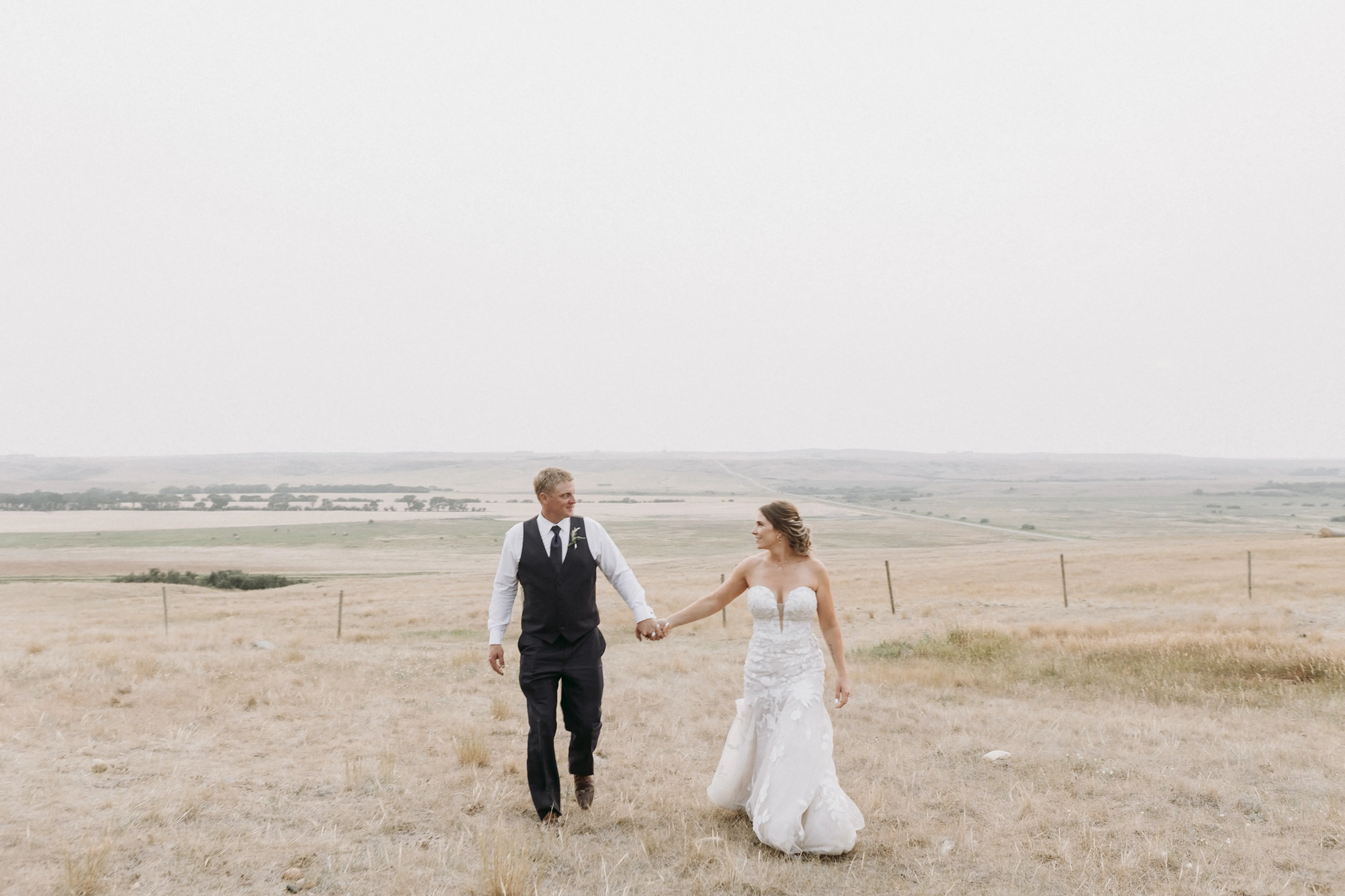 Bride with groom wearing strapless mermaid wedding dress