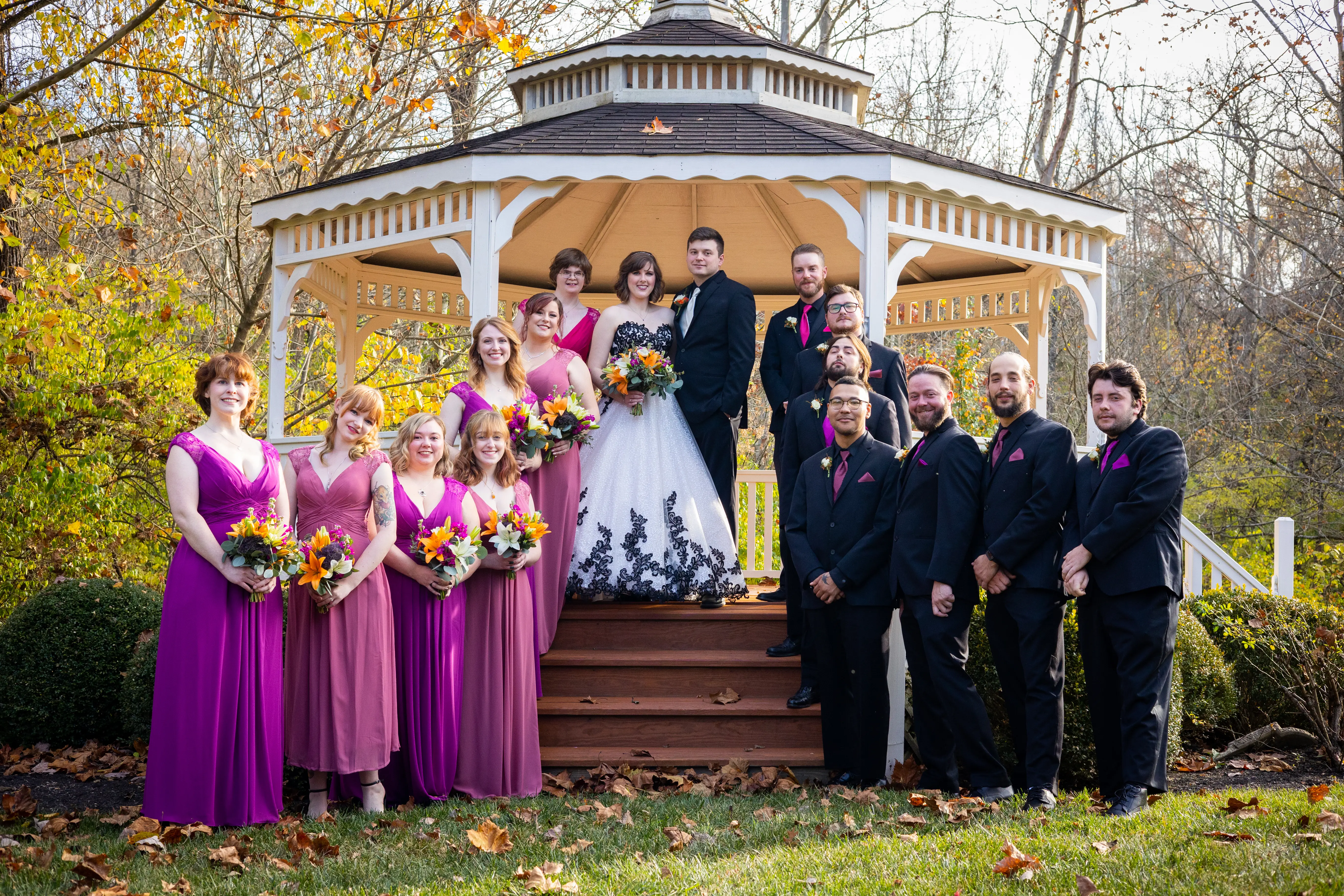Bridal Party Standing Together. Bride Wearing Black And White Lace Strapless Ball Gown Called Tristyn By Maggie Sottero