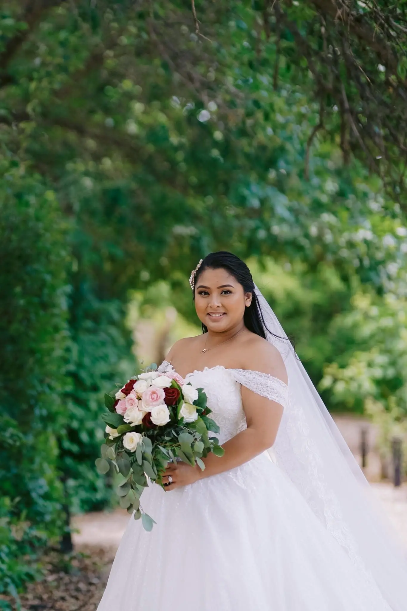 Bride smiling wearing wedding dress called Tristyn.