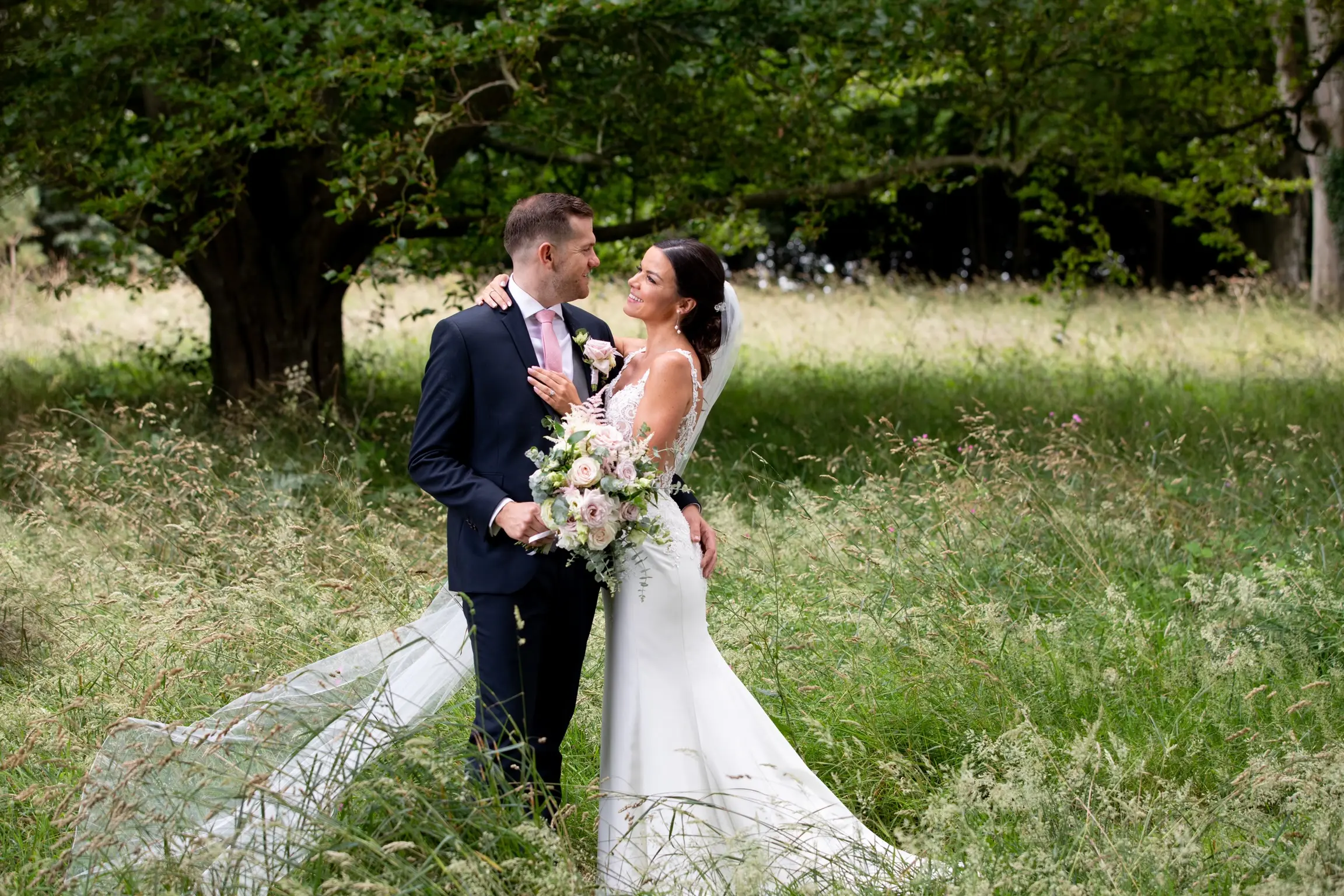 Bride with groom wearing crepe sheath wedding dress