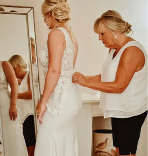 Mom Helping Bride Get Ready Wearing Aidan Lace Sheath Bridal Dress Called Aidan By Maggie Sottero