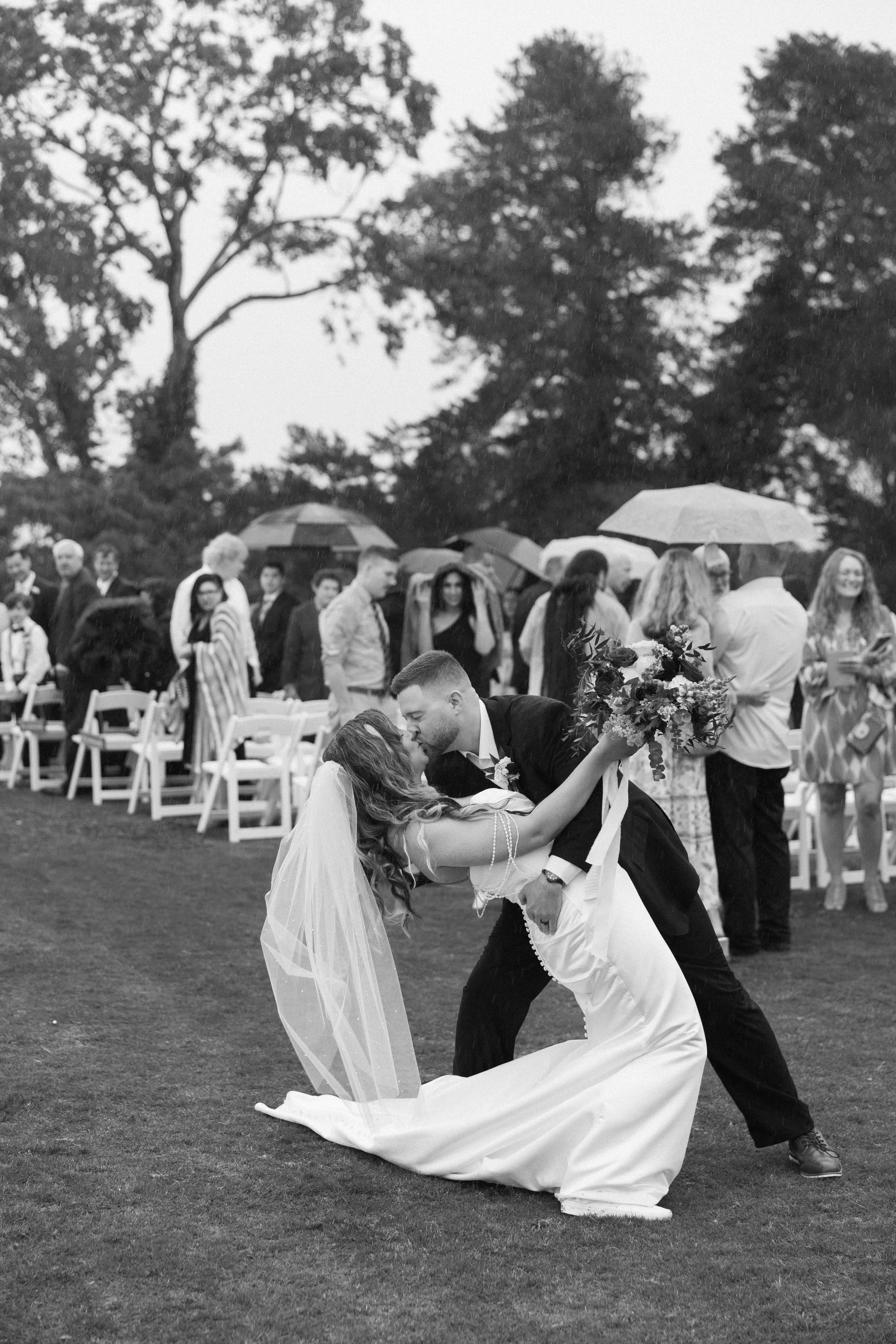 Bride wearing Clover by Rebecca Ingram kissing her husband after their ceremony