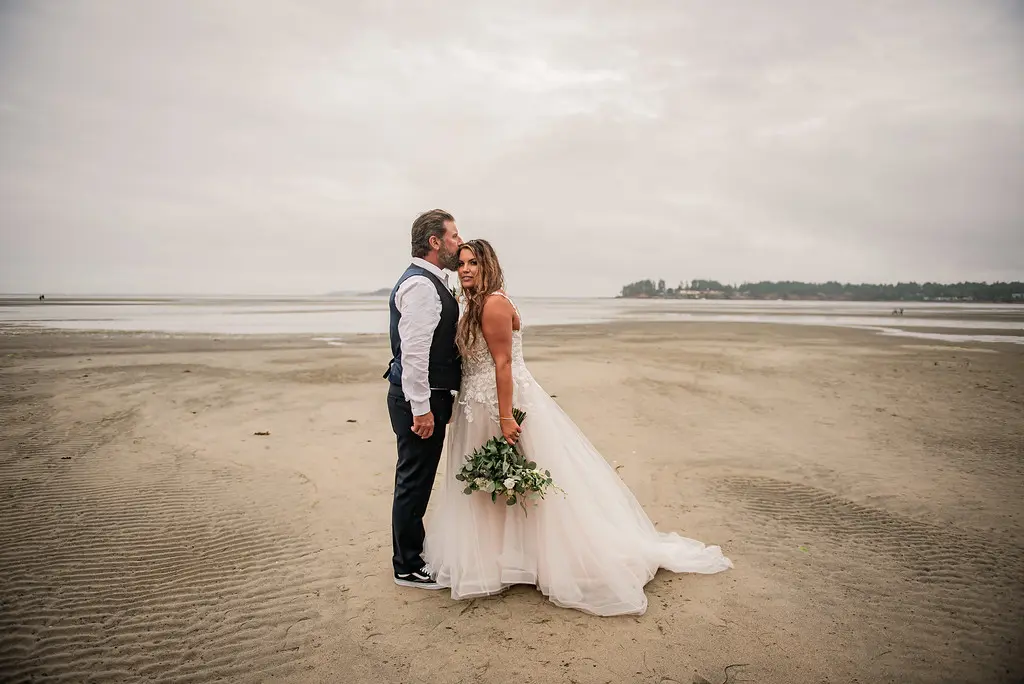 Bride wearing Boho Wedding Dress called Stevie by Maggie Sottero on the beach with her groom