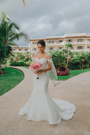 Bride Wearing Sparkly Fit And Flare Wedding Dress Called Anniston Lane By Maggie Sottero Holding A Vibrant Pink Bouquet