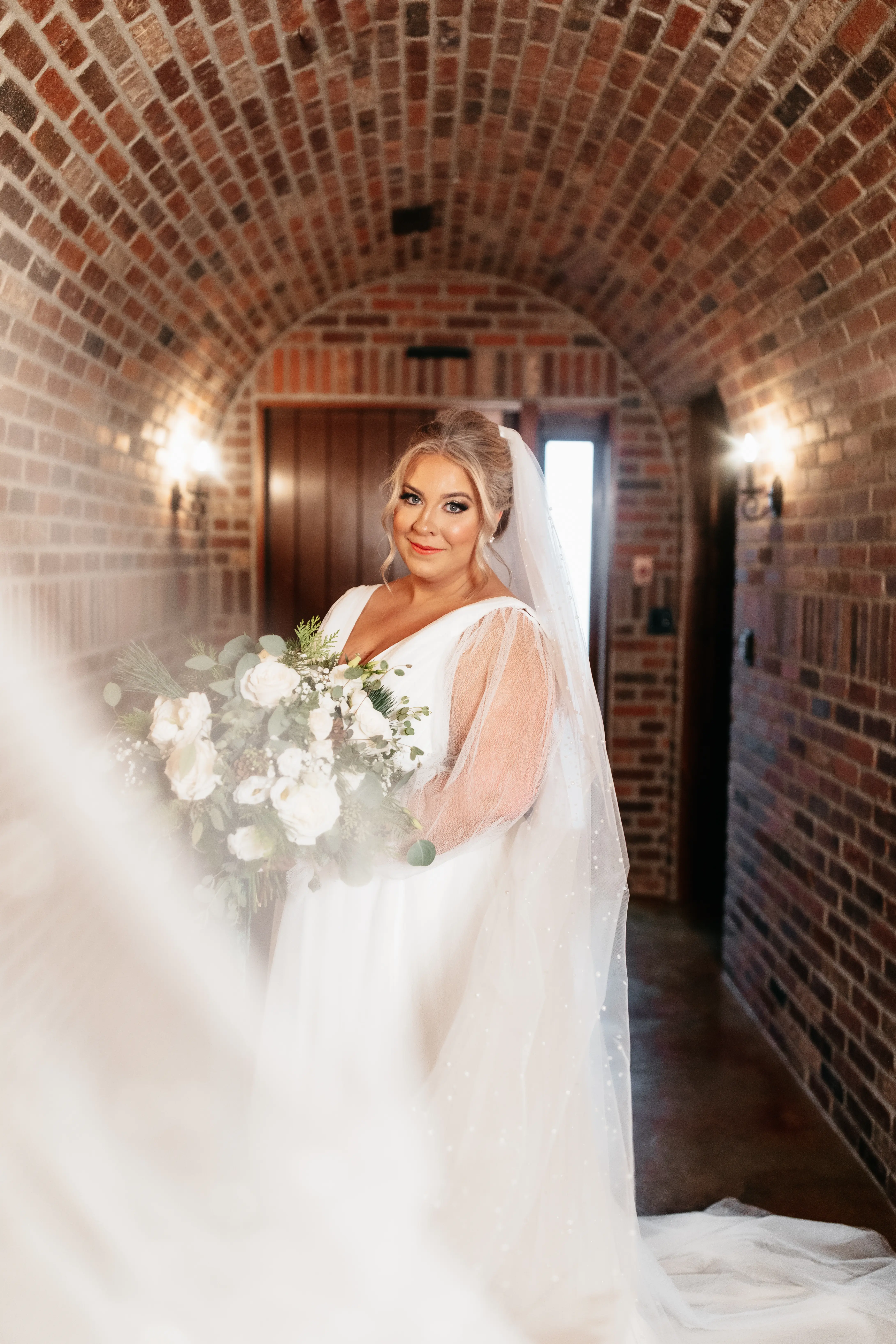 Bride wearing Joanne wedding dress by Rebecca Ingram holding her bouquet