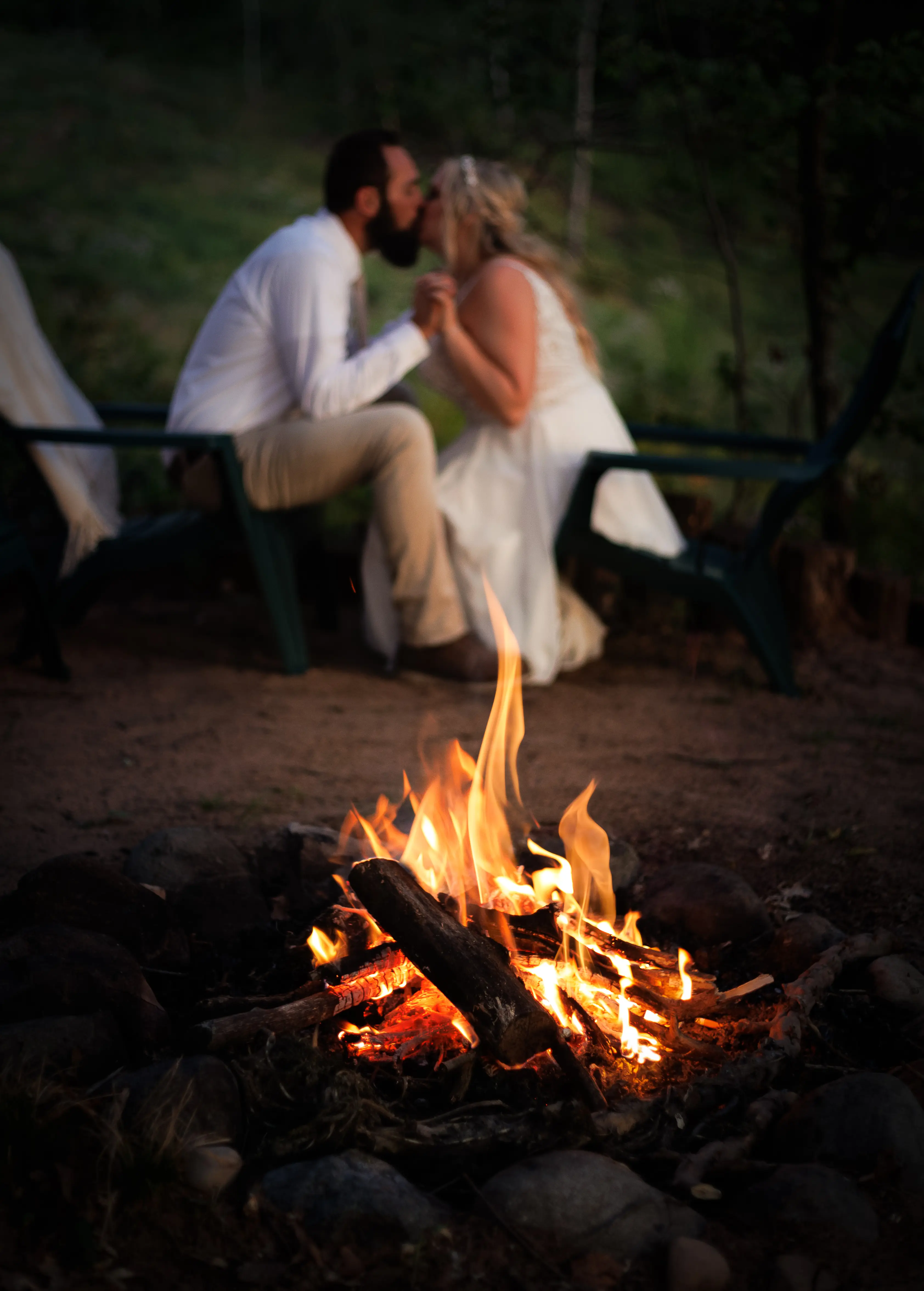 Bride Wearing Beaded Wedding Dress With Flowy Skirt Called Lorraine By Rebecca Ingram Kissing Groom By Intimate Fire