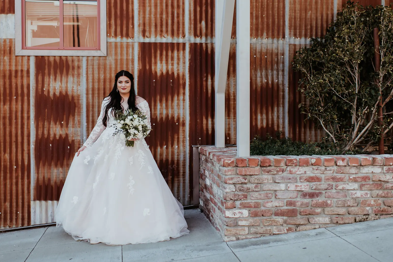 Bride Wearing Long Sleeve Lace Wedding Dress Called Raphael By Maggie Sottero By A Rustic Venue