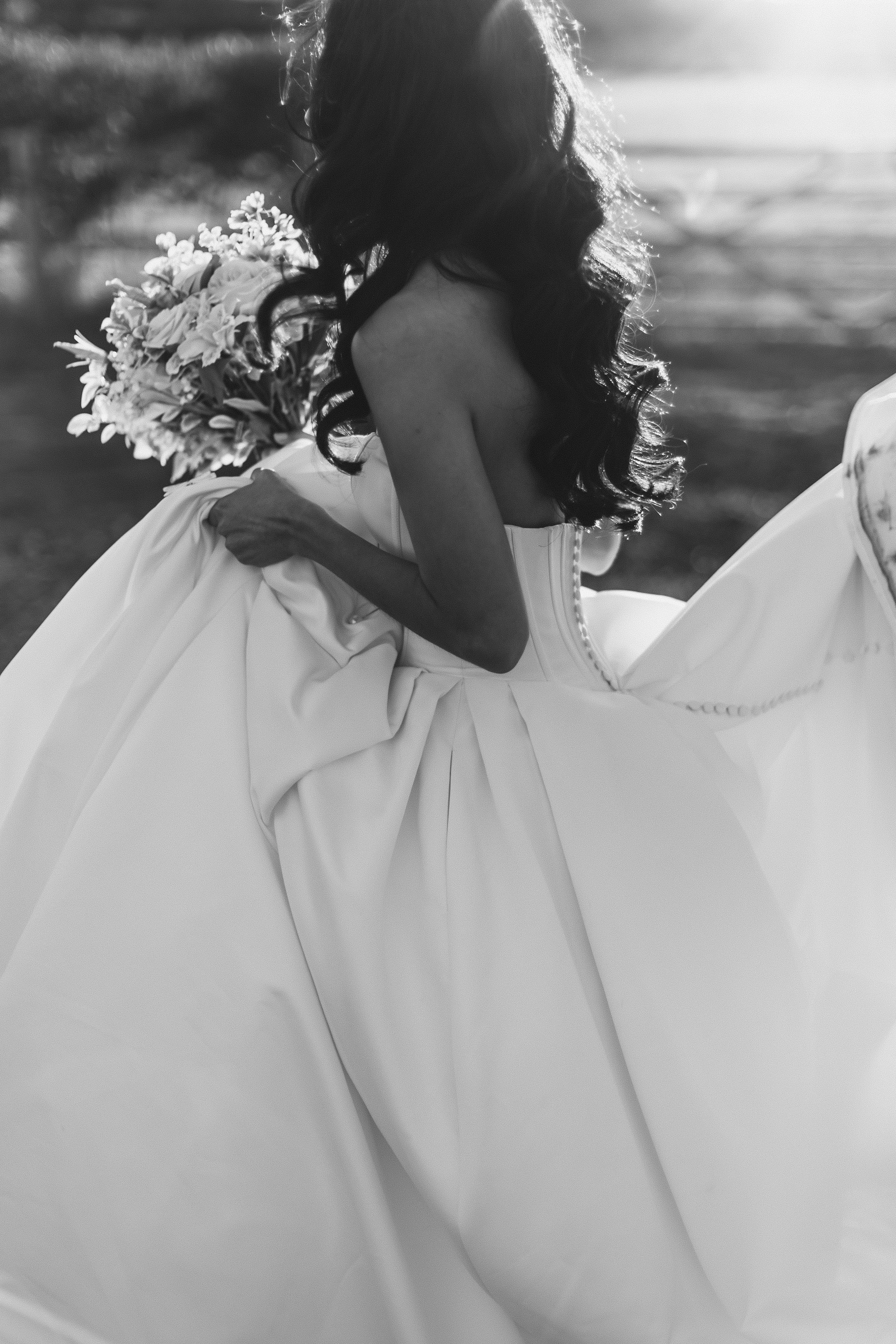 Bride wearing Derrick by Maggie Sottero carrying her bouquet