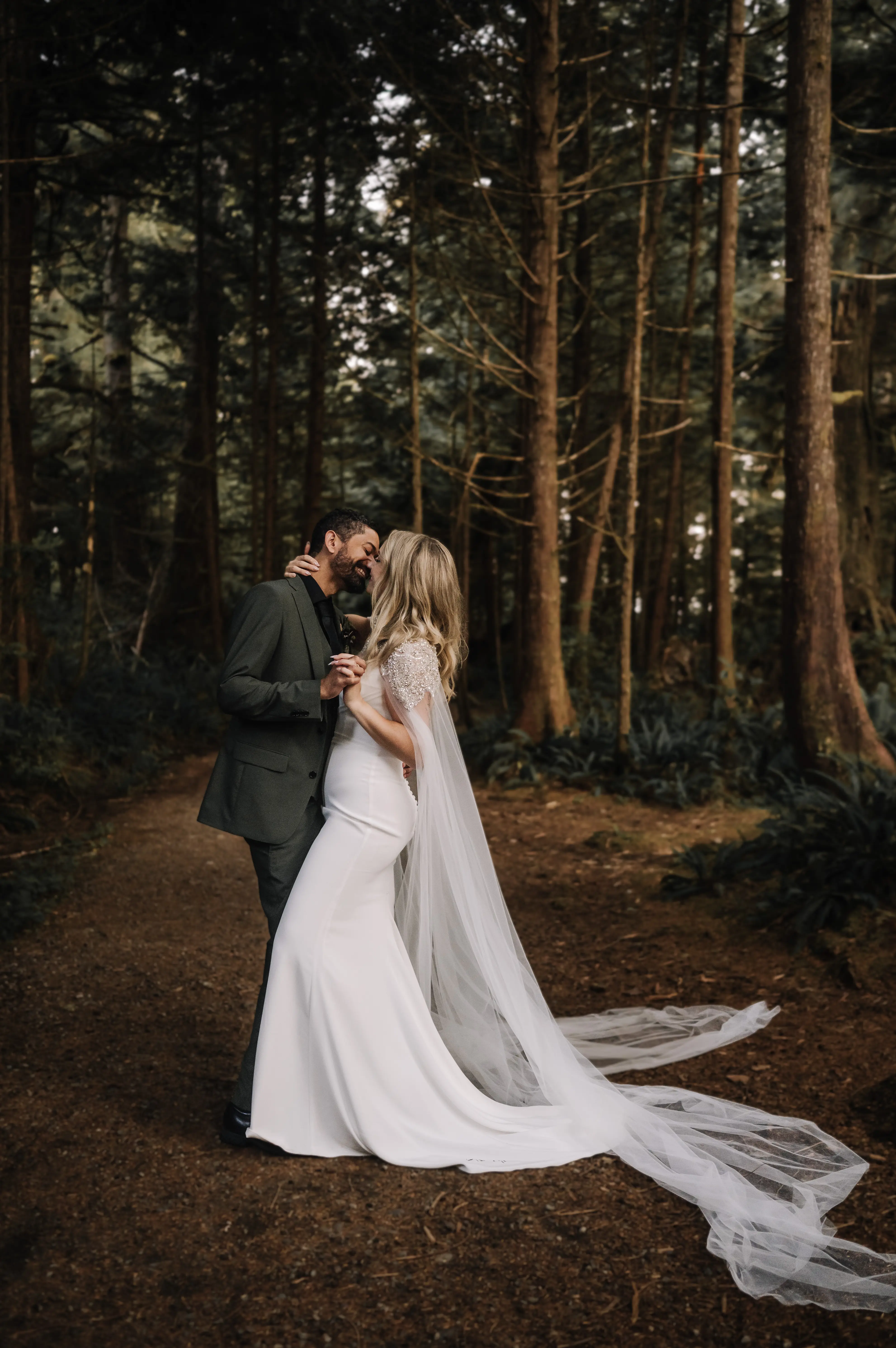 Bride wearing Summer wedding dress by Maggie Sottero kissing husband