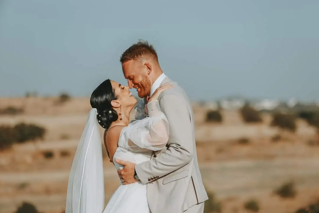 Groom Holding Bride Wearing Boho A-Line Wedding Dress Called Nerida By Sottero And Midgley